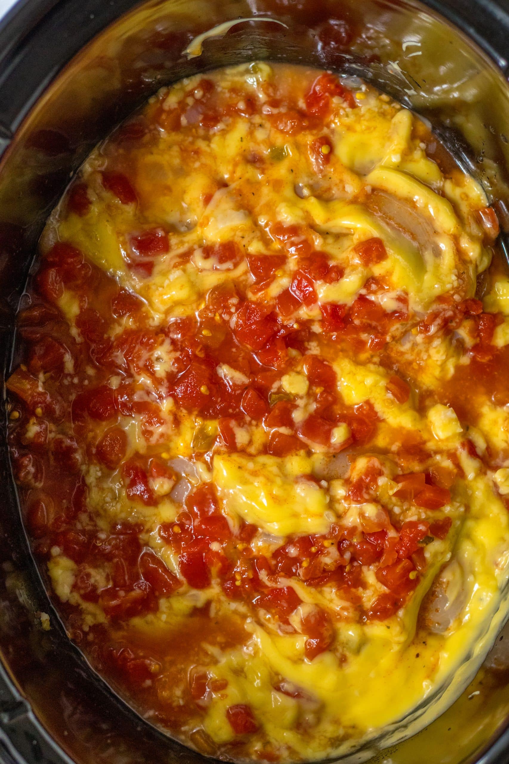 slow cooker chicken spaghetti ingredients in the black bowl of a crockpot