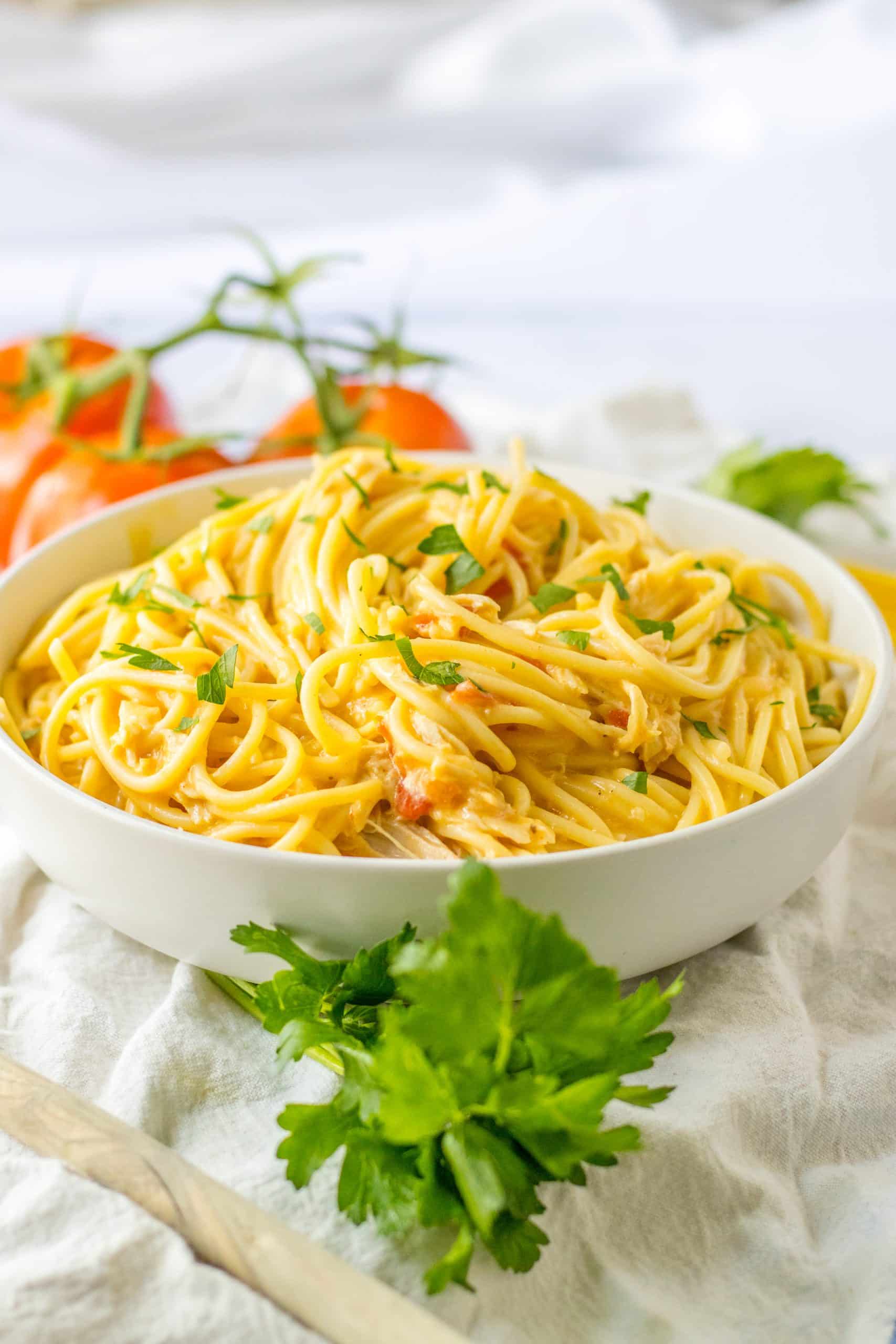 slow cooker chicken spaghetti in a white serving bowl