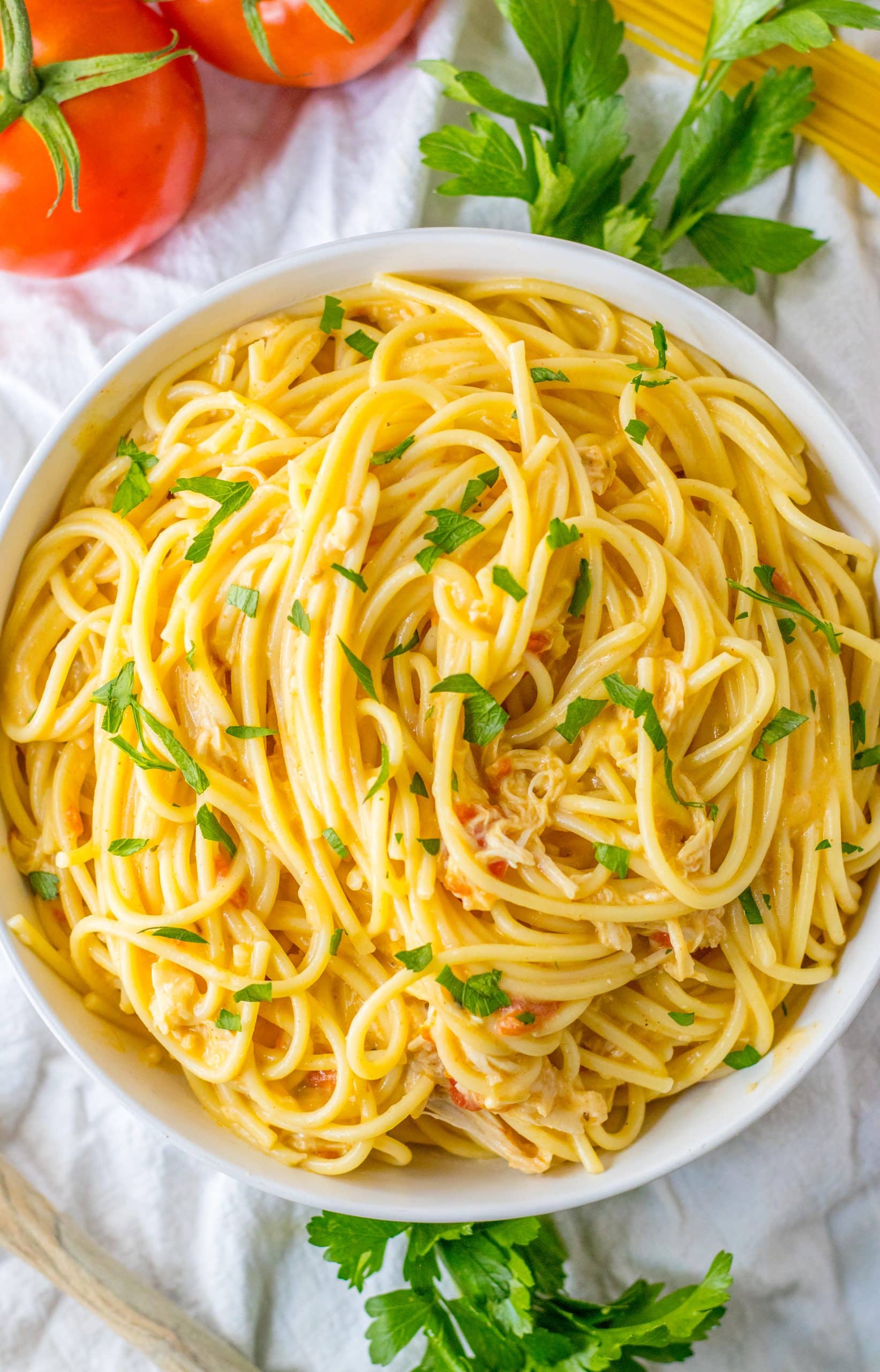 slow cooker chicken spaghetti in a white serving bowl