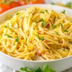 slow cooker chicken spaghetti in a white serving bowl
