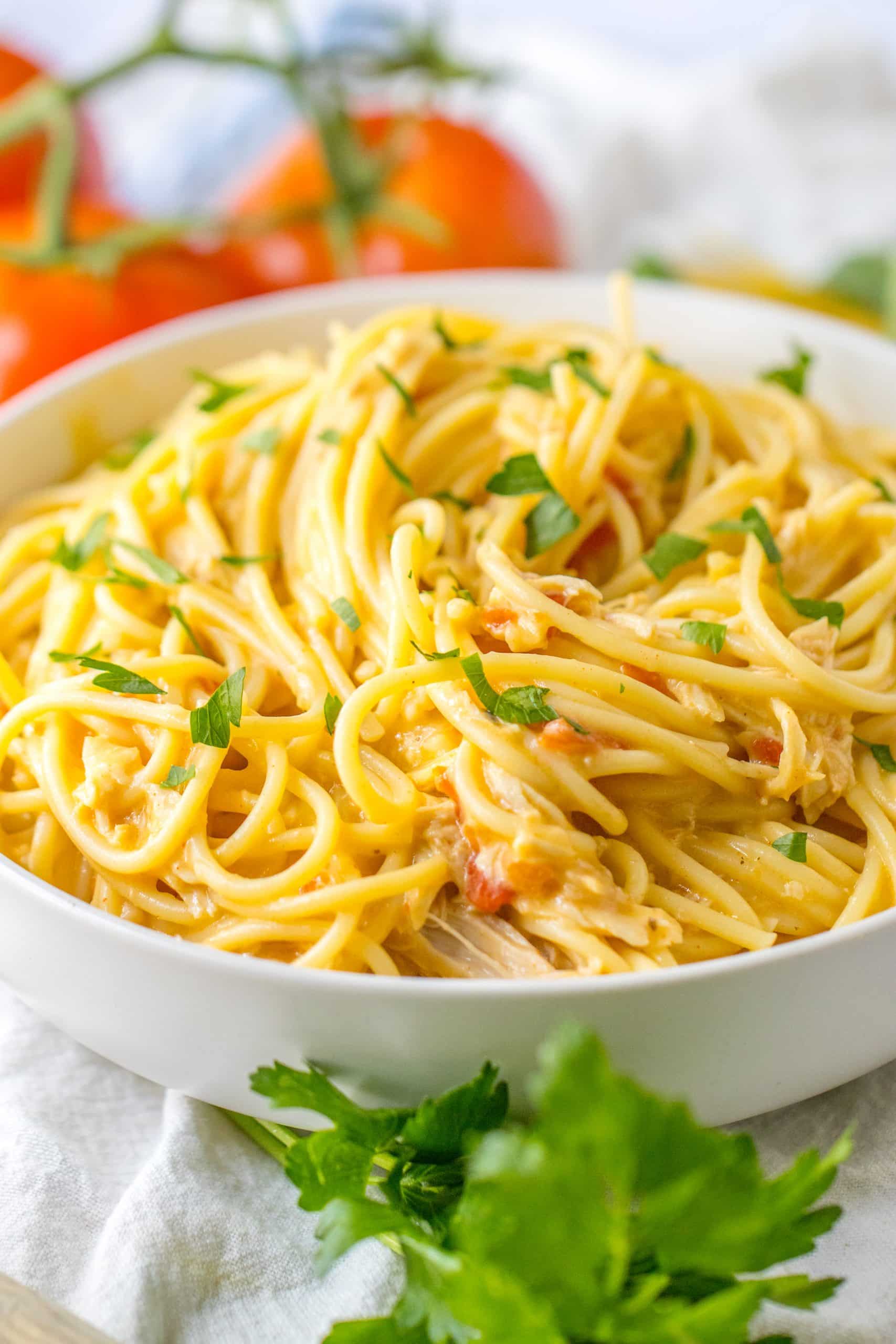 slow cooker chicken spaghetti in a white serving bowl