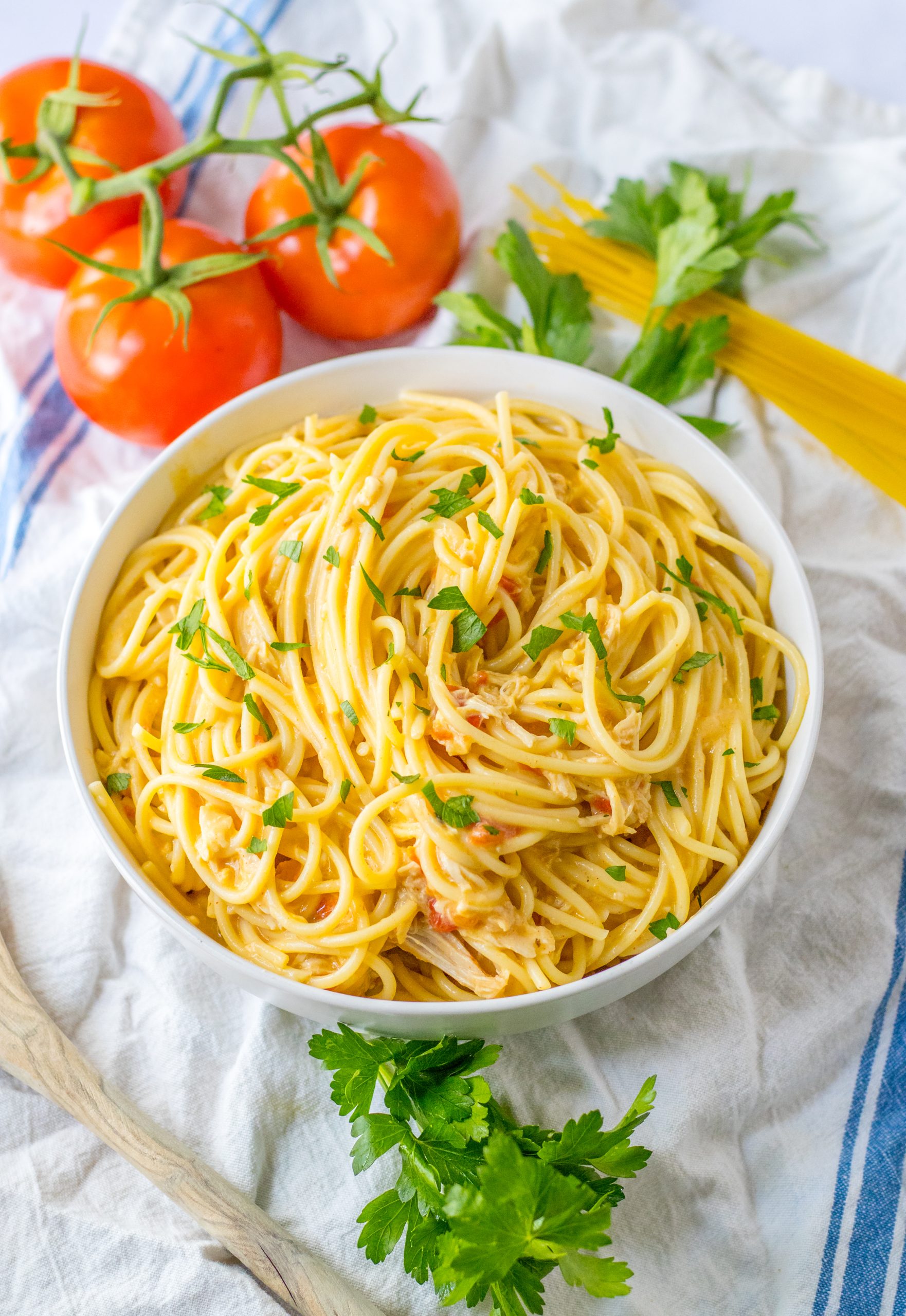 slow cooker chicken spaghetti in a white serving bowl