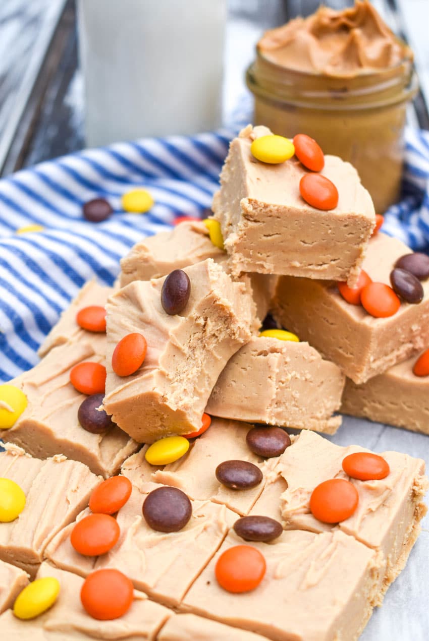 squares of two ingredient peanut butter fudge stacked on top of each other