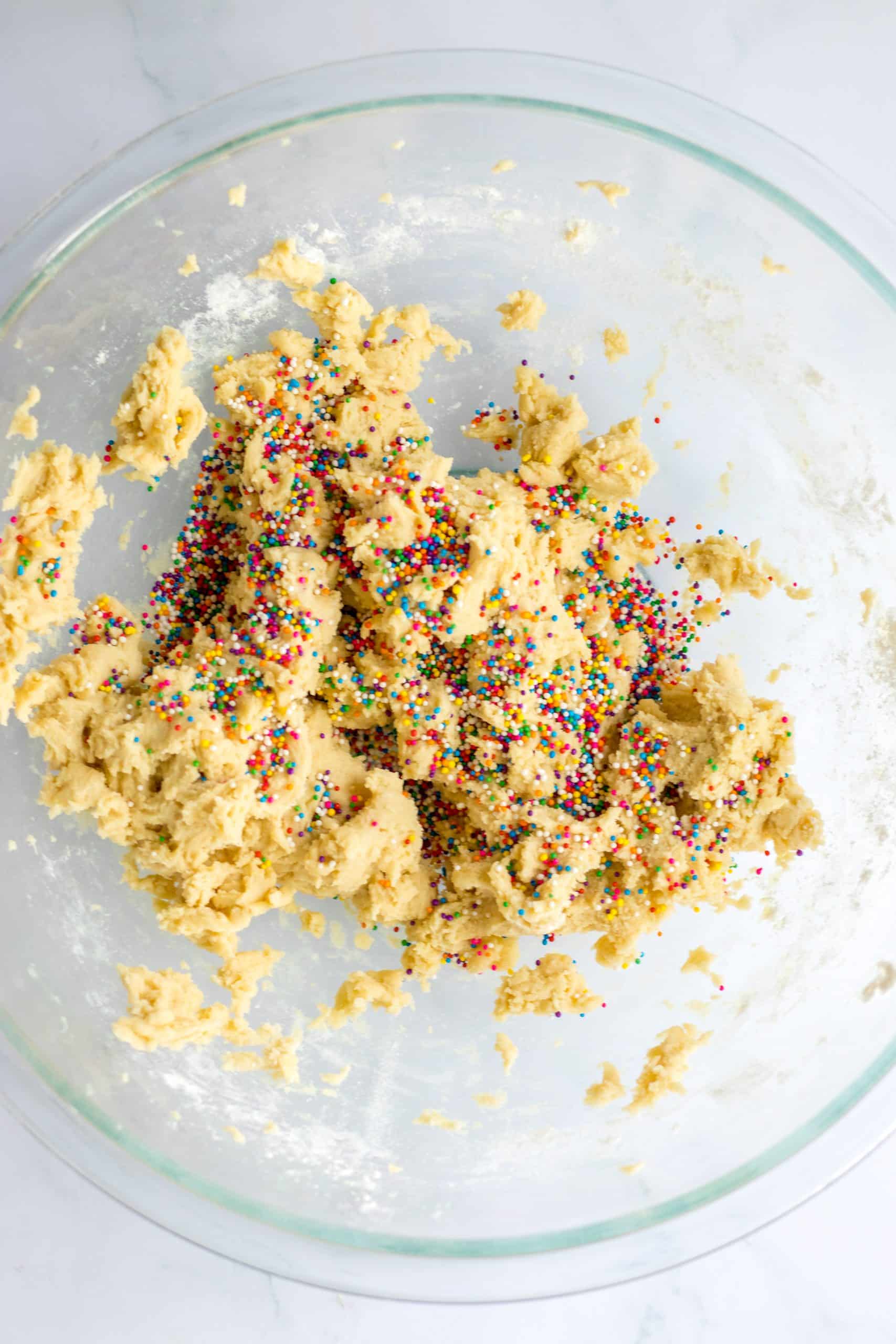 sprinkled cookie dough in a glass mixing bowl