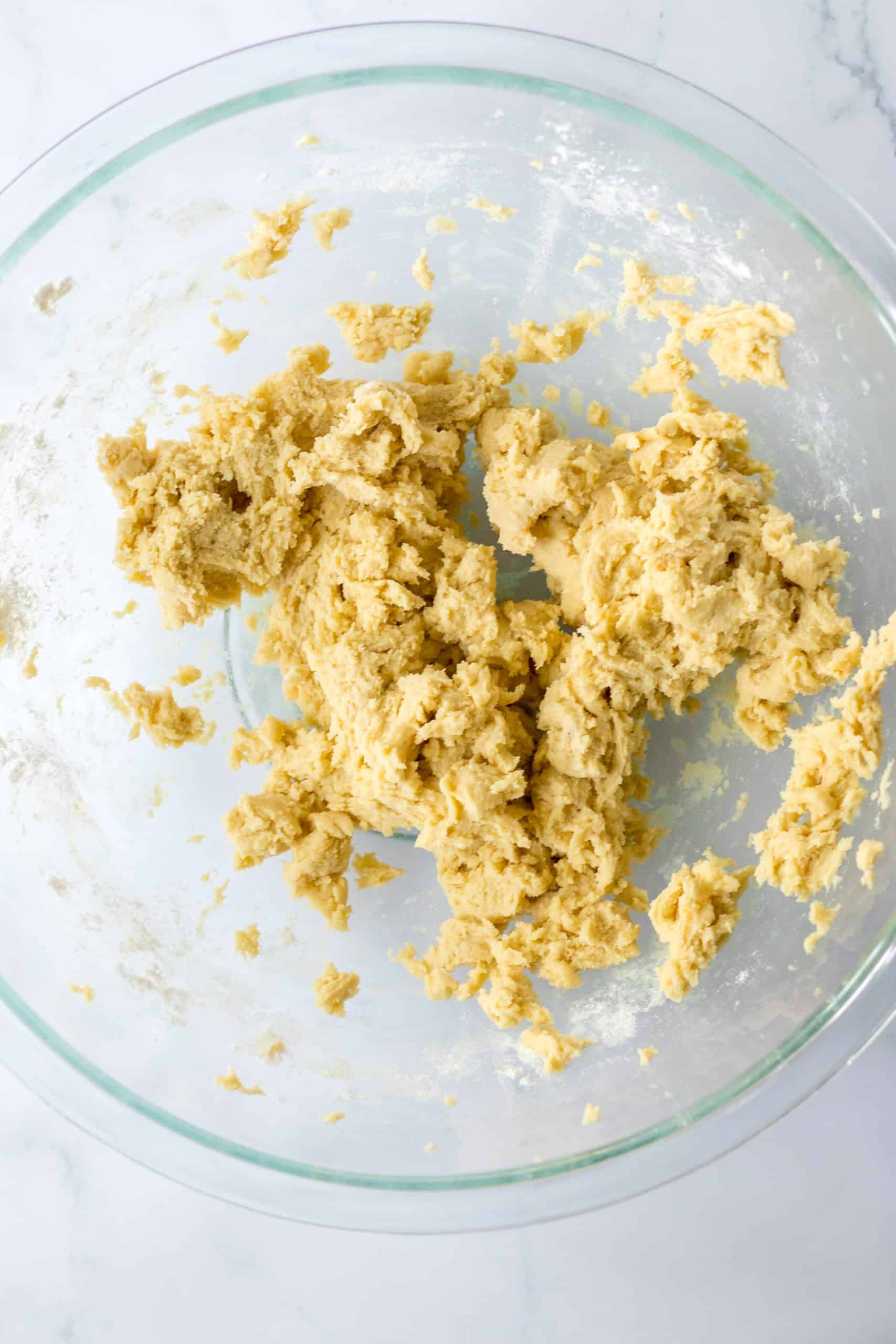 cookie dough in a glass mixing bowl