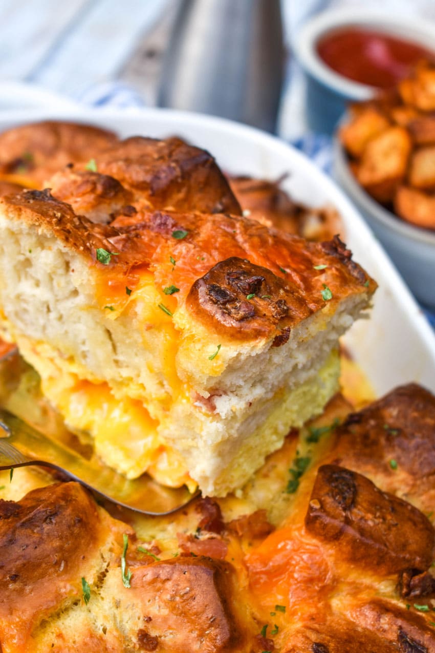 a slice of breakfast bubble up biscuit casserole resting on a silver spatula