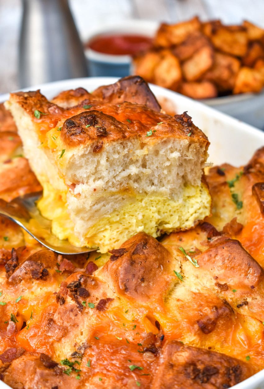 a slice of breakfast bubble up biscuit casserole resting on a silver spatula