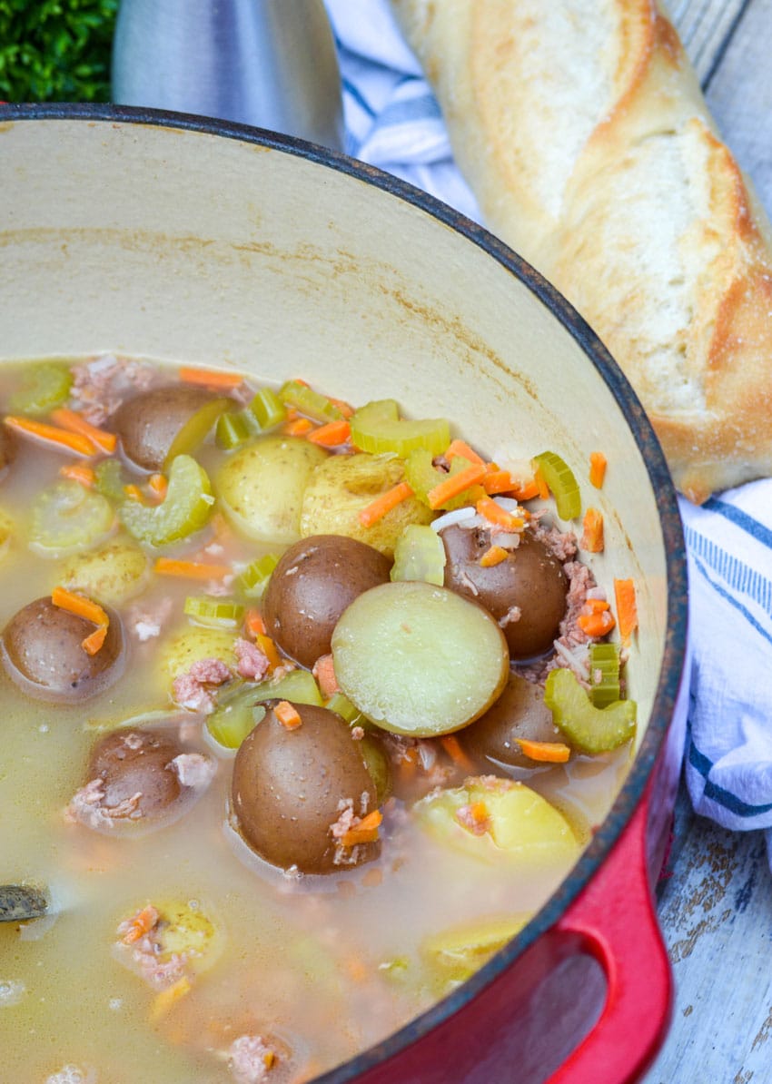 canned corned beef stew in a red dutch oven