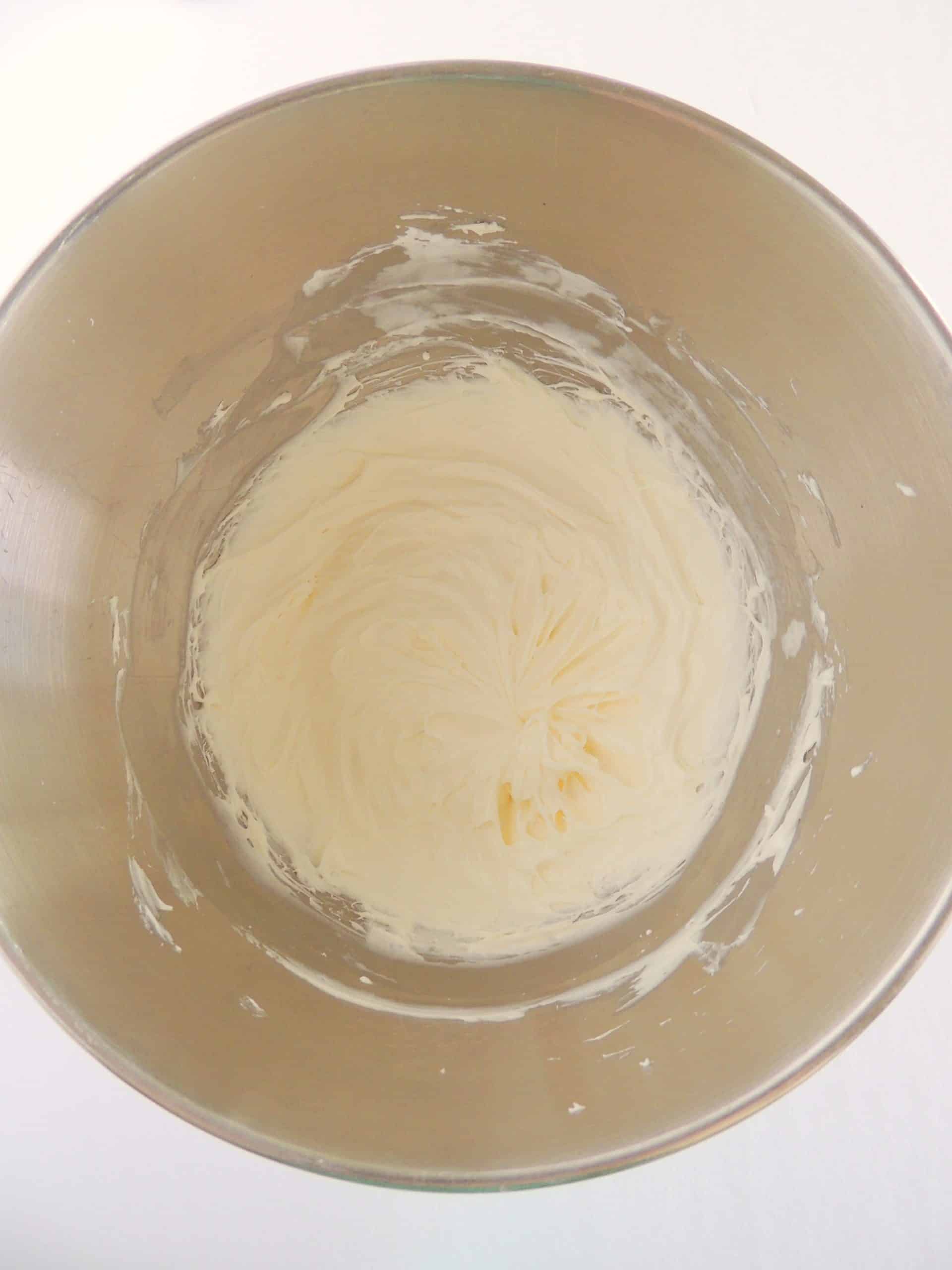 whipped cream cheese and marshmallow fluff in a large metal mixing bowl