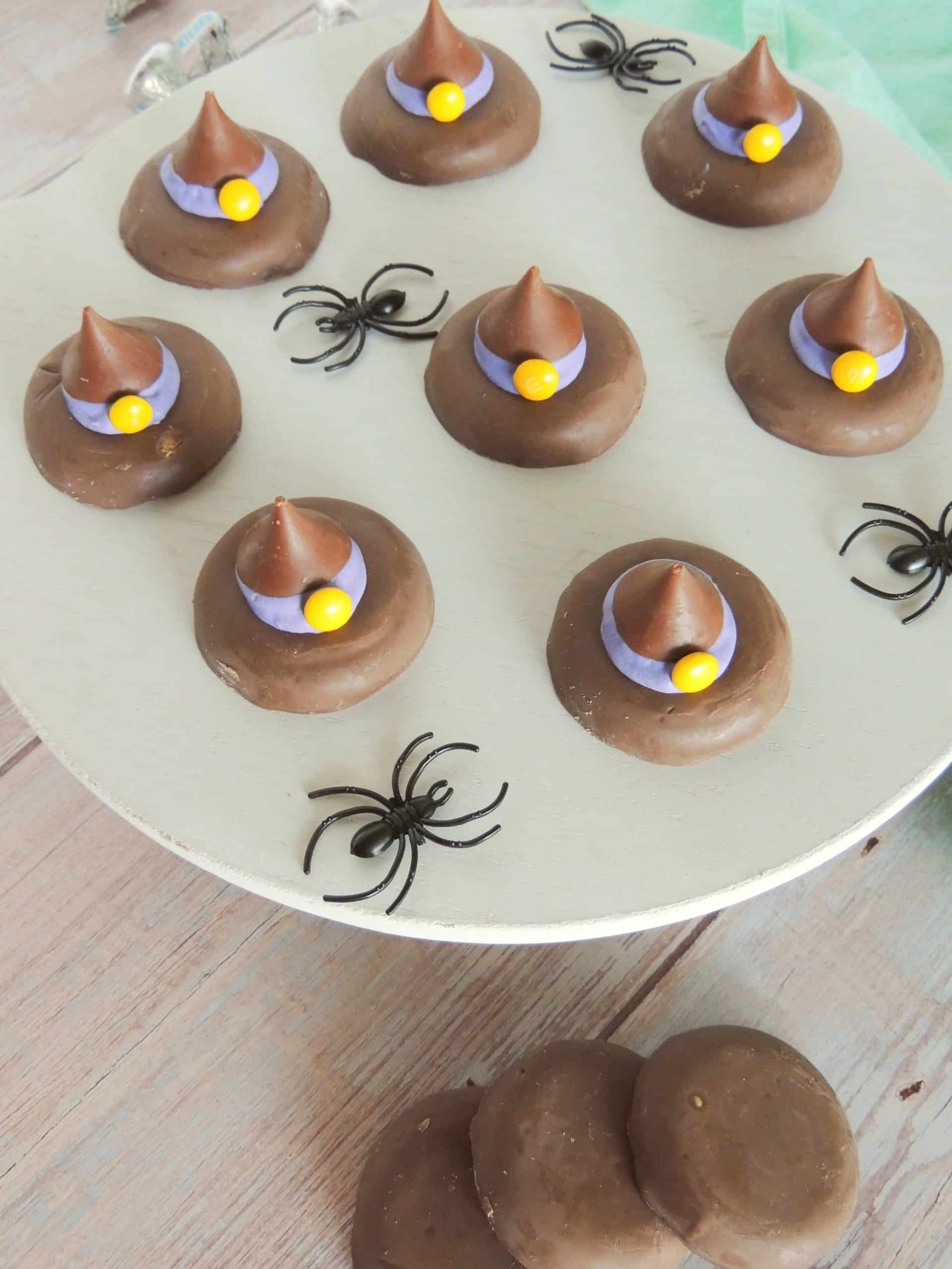 easy witch hat cookies on a white cake stand