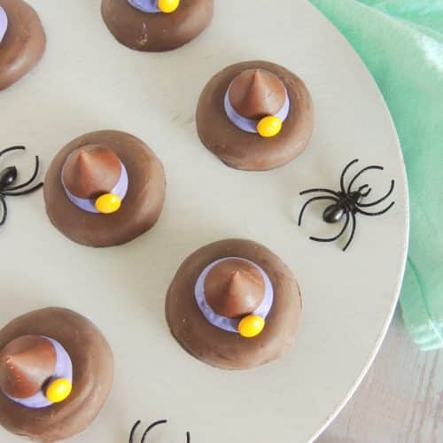easy witch hat cookies on a white cake stand