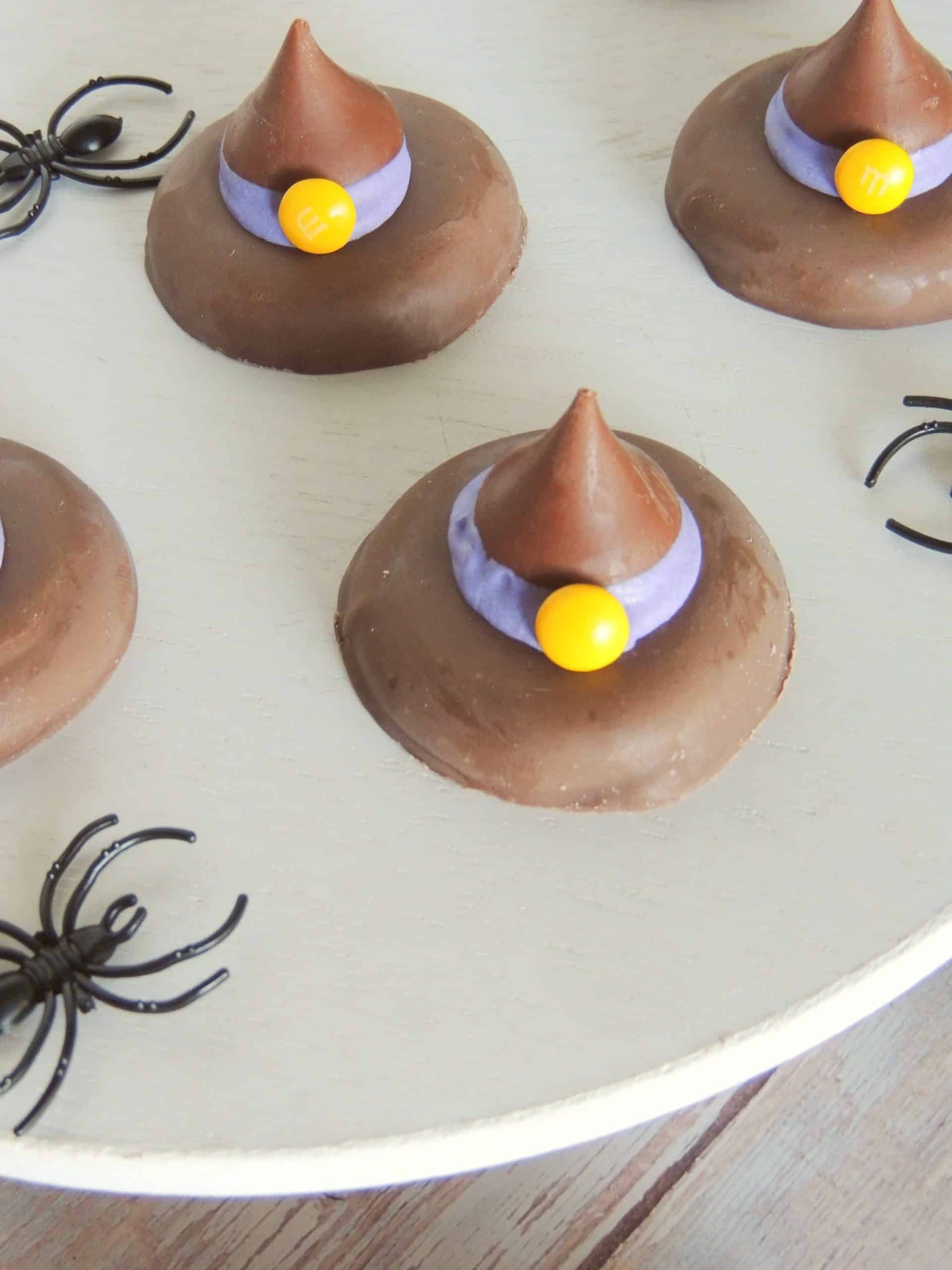 easy witch hat cookies on a white cake stand