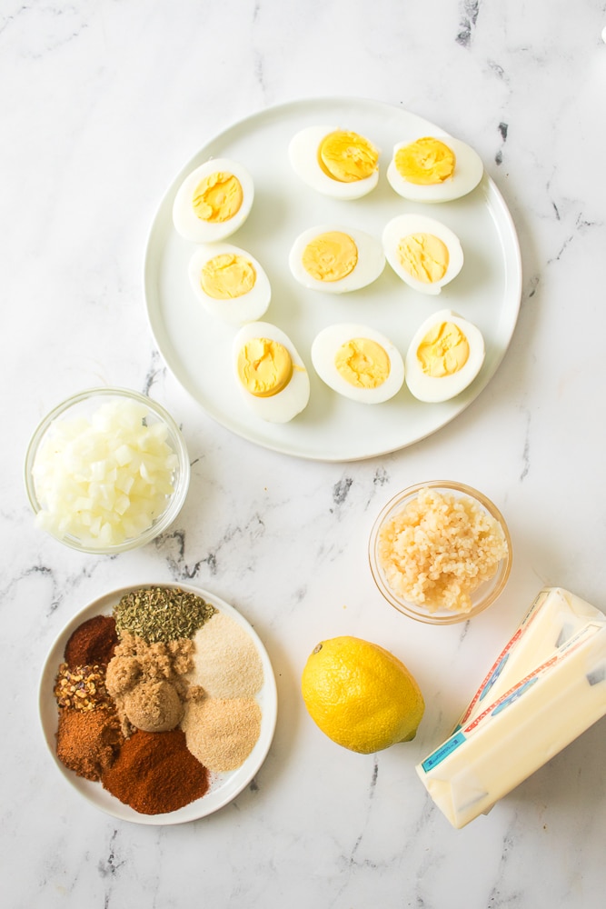 an overhead image showing the measured ingredients needed to make an egg boil in a skillet