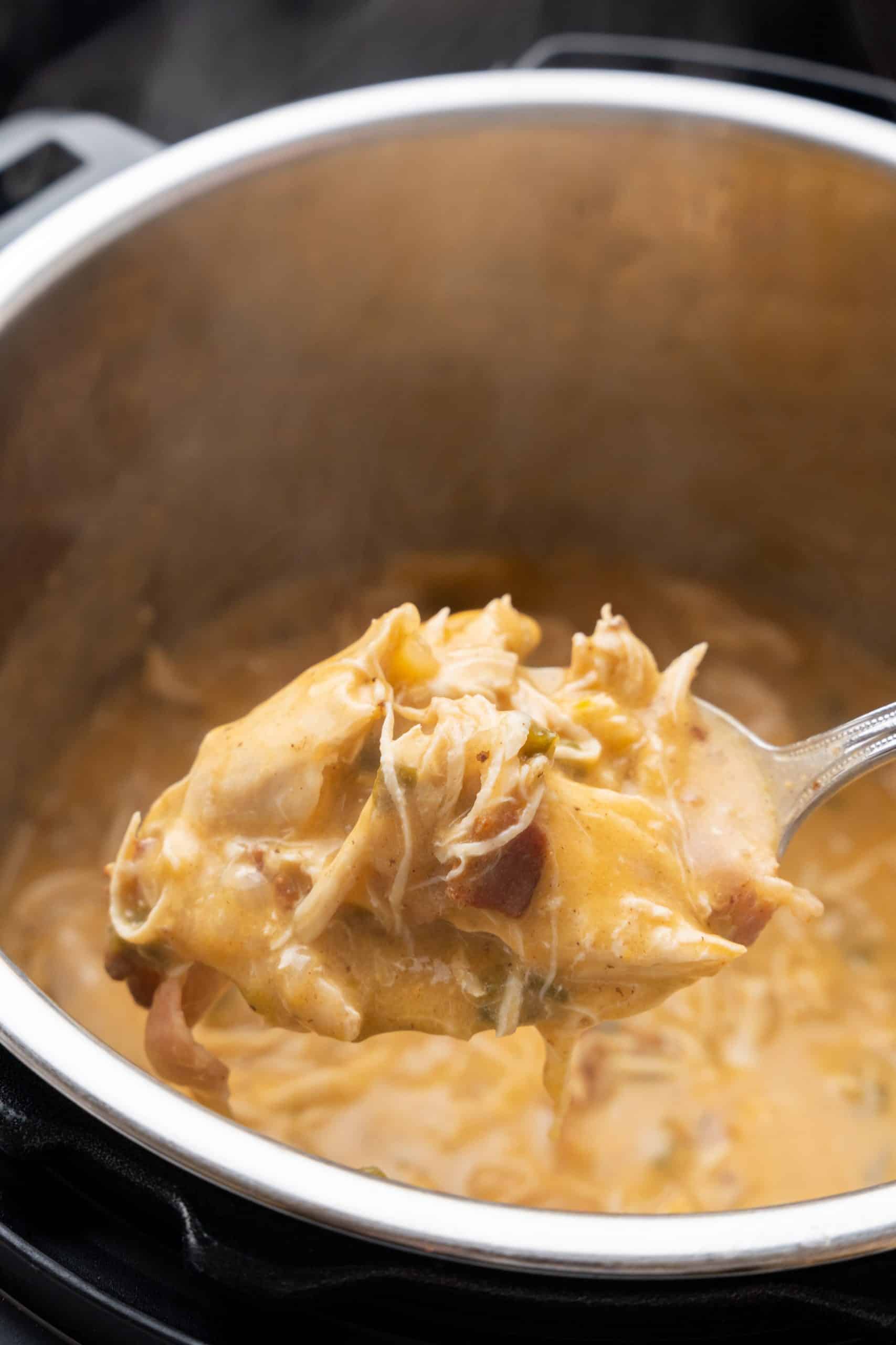 a silver spoon scooping jalapeno cheddar chicken out of an instant pot