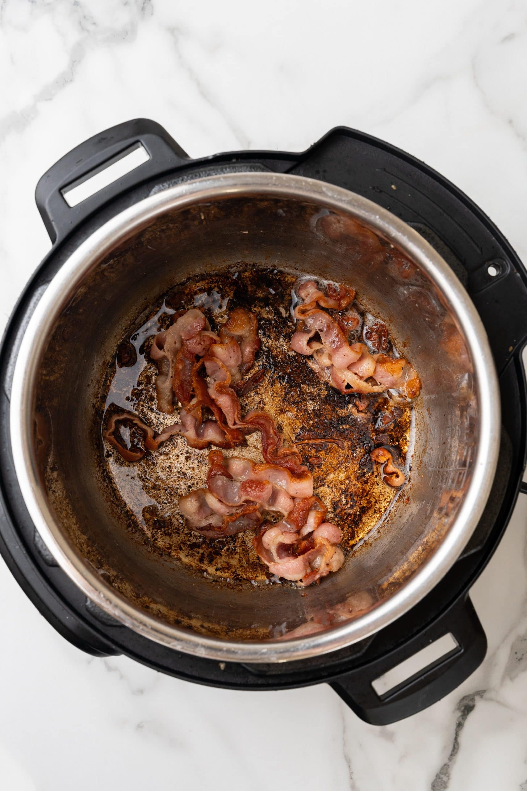 crispy bacon cooked in the bowl of an instant pot