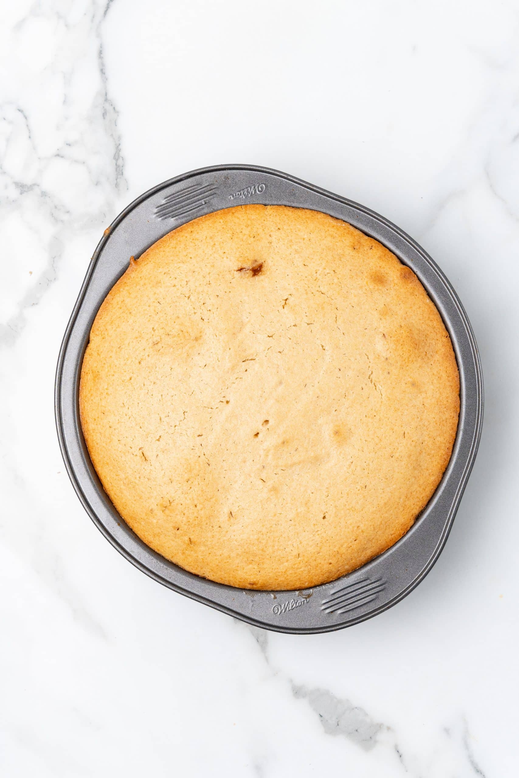 baked upside down apple cake in a round metal cake pan