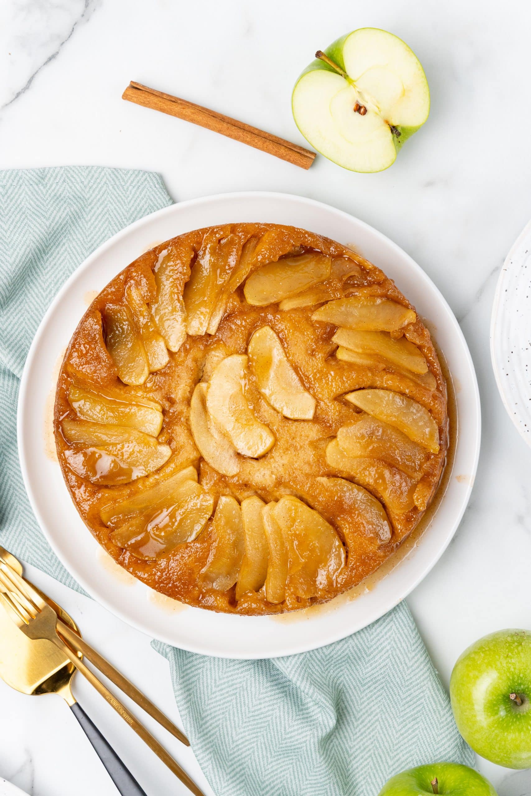 upside down apple cake on a white serving plate