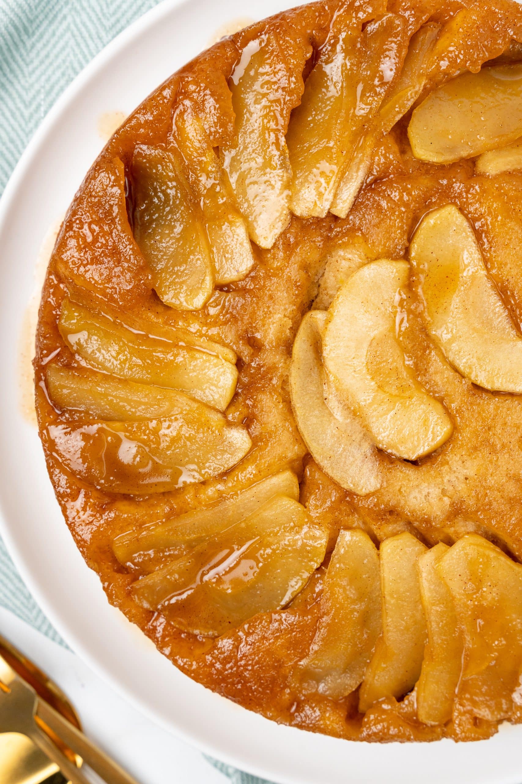 apple upside down cake on a white serving plate