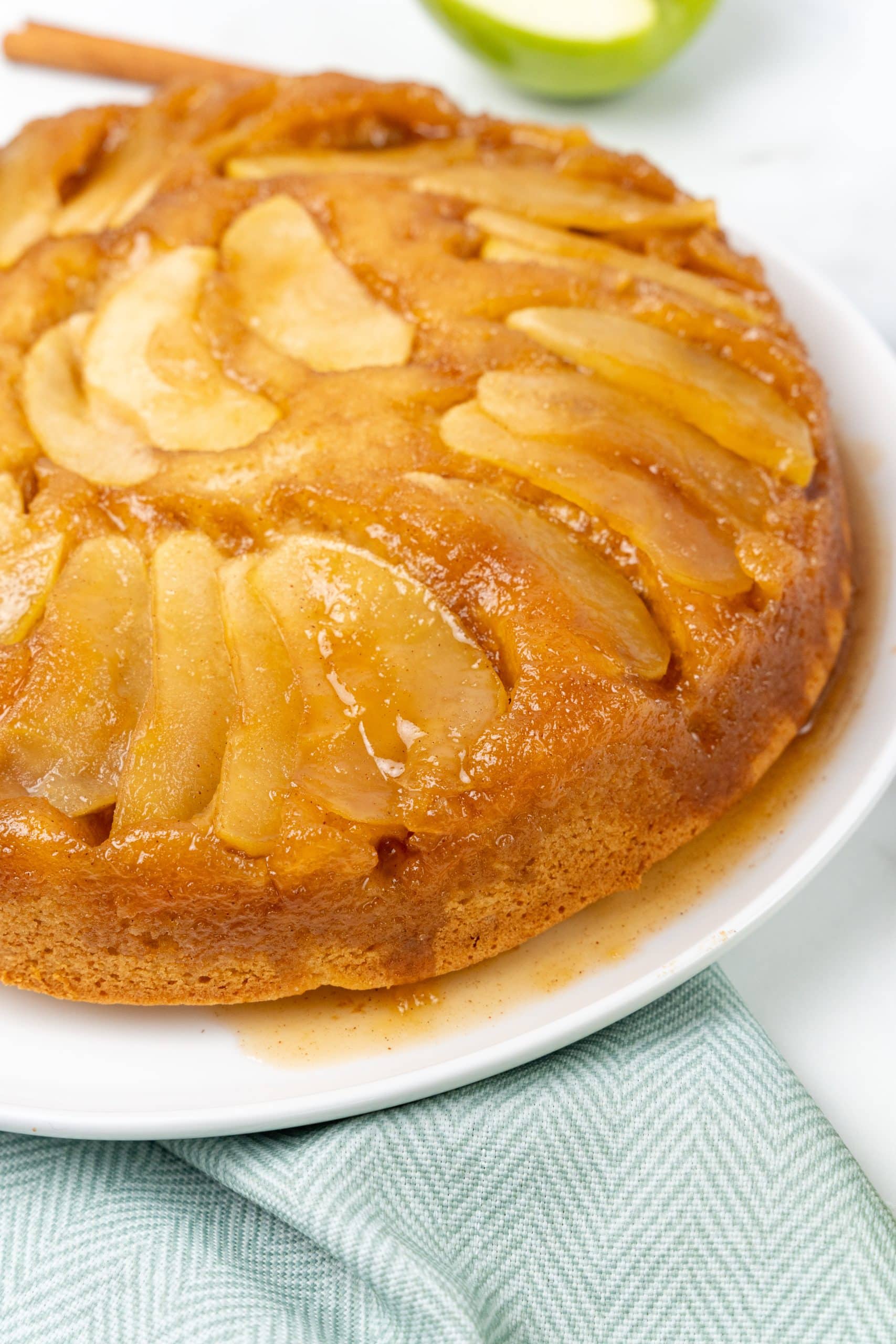 apple upside down cake on a white serving plate
