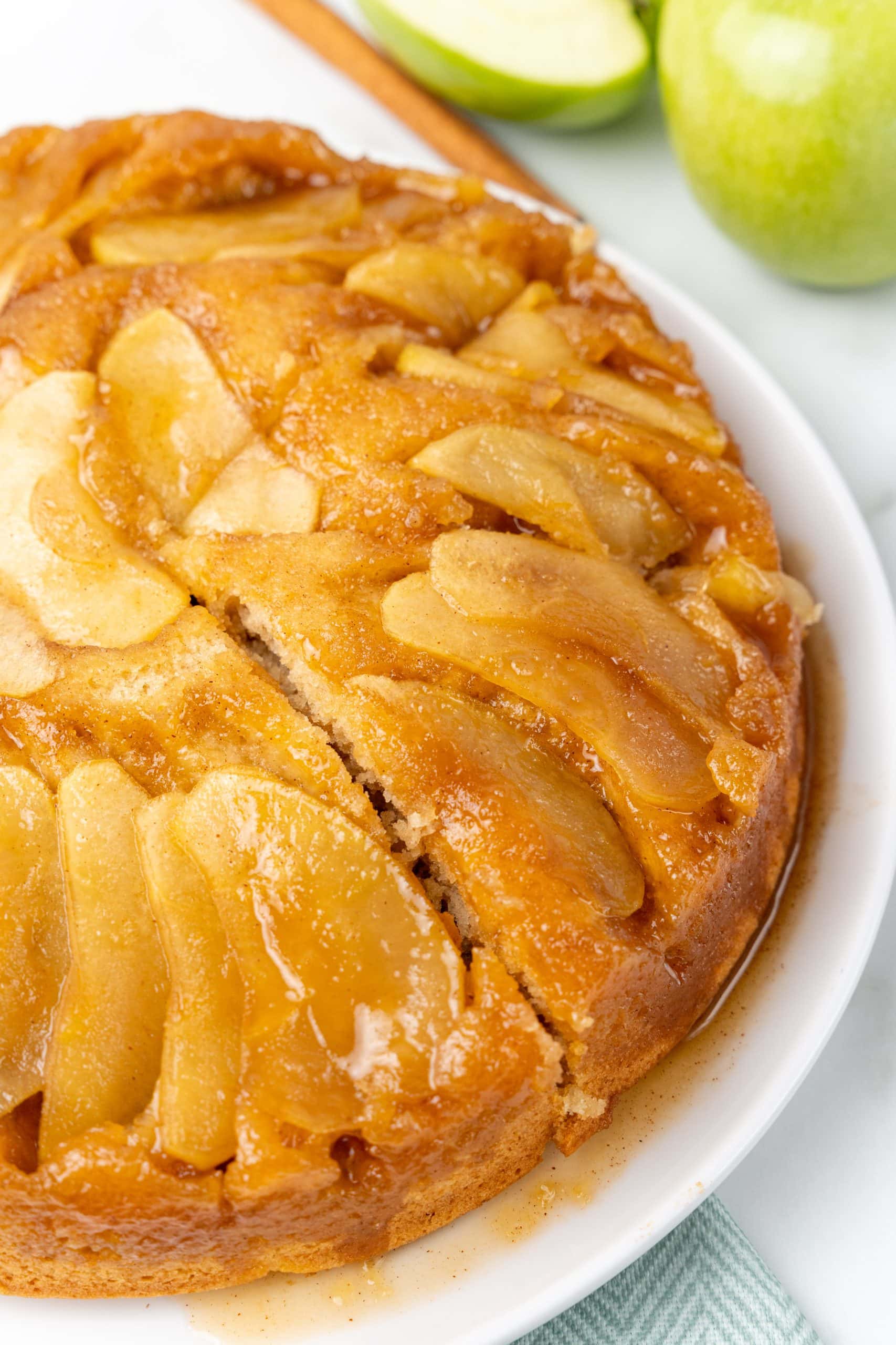 upside down apple cake on a white serving plate