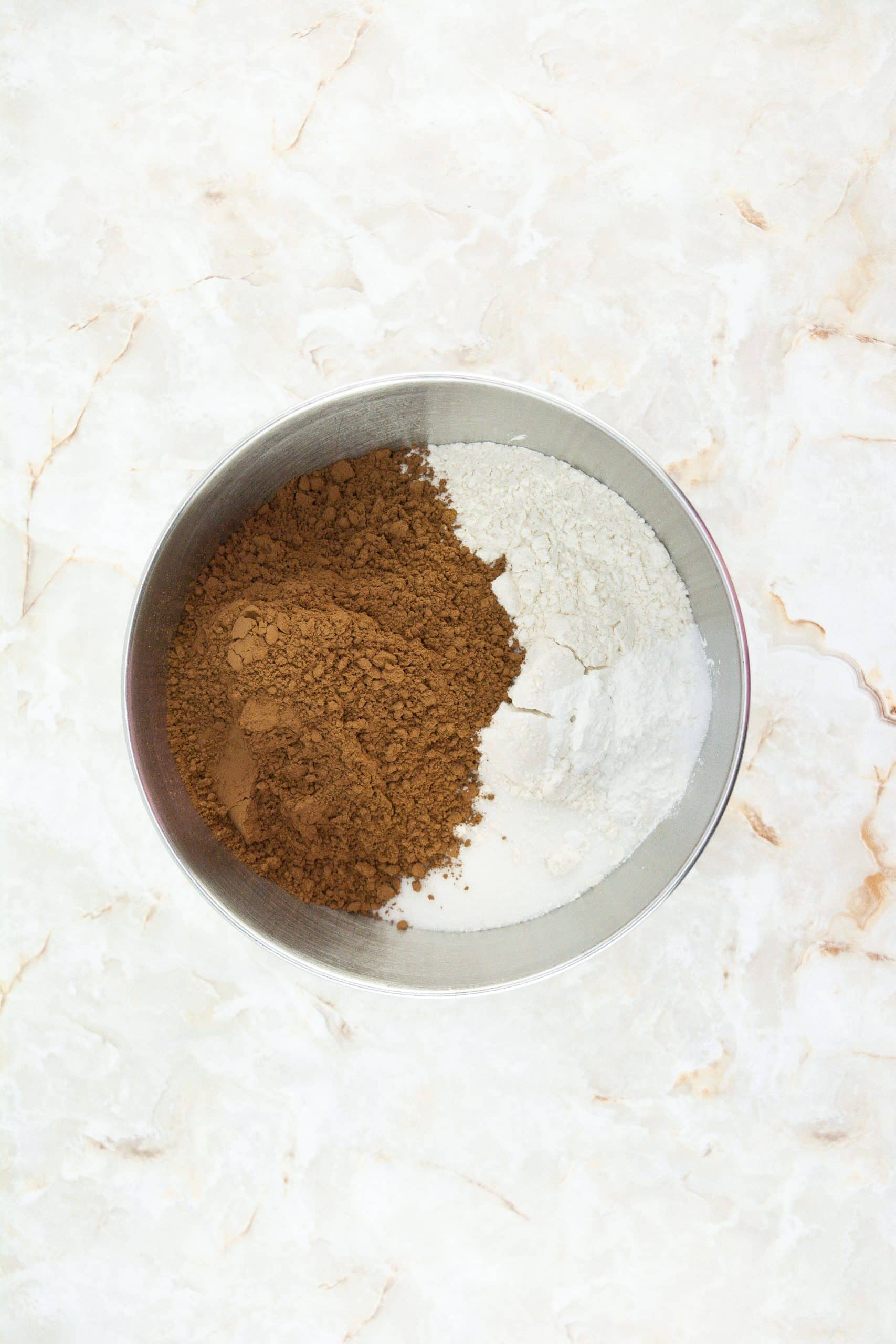 dry ingredients for chocolate cupcakes in a metal mixing bowl