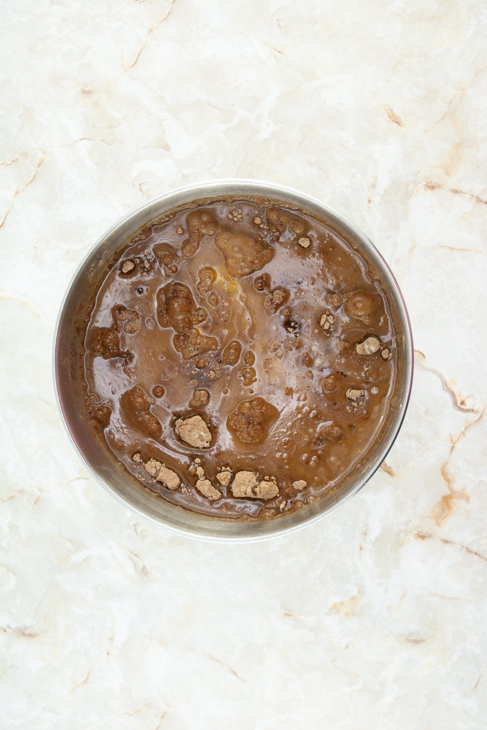 homemade chocolate cupcake batter in a metal mixing bowl
