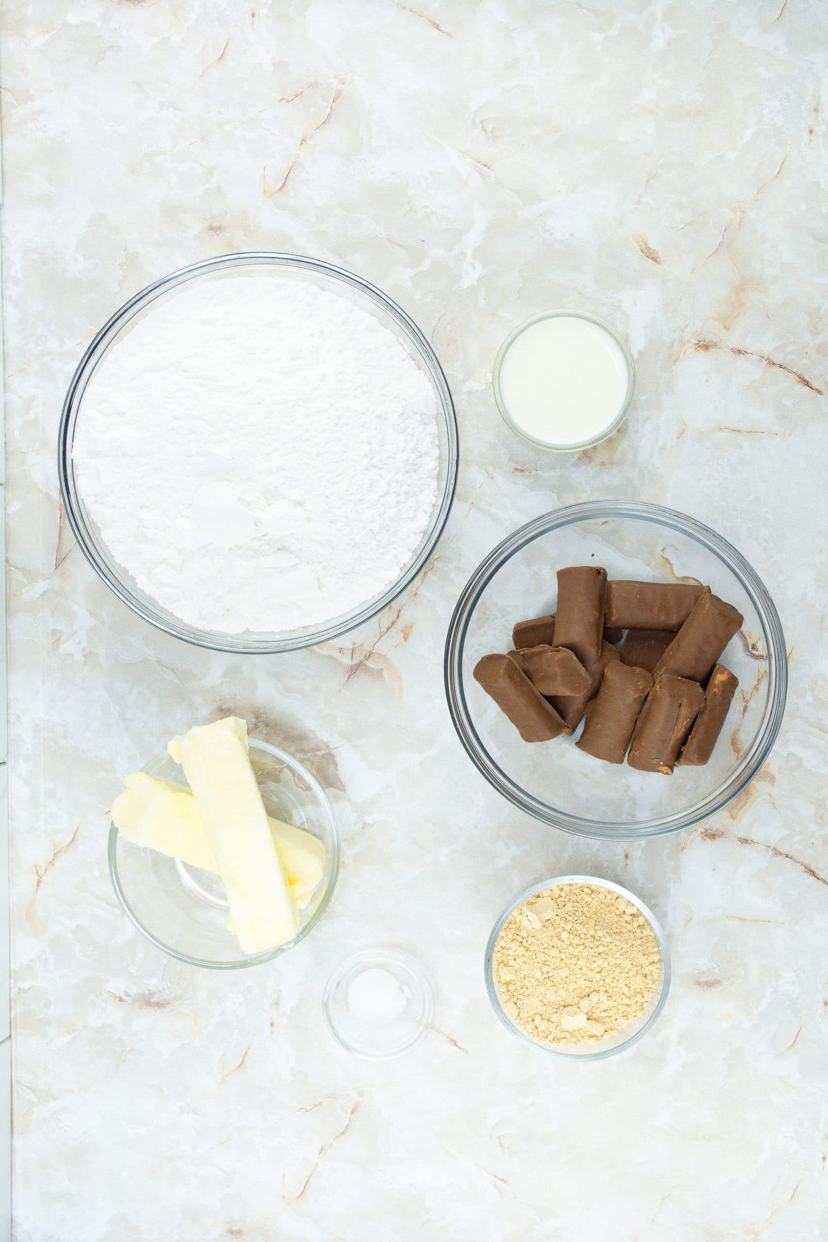 an overhead image showing the measured ingredients needed to make butterfinger frosting