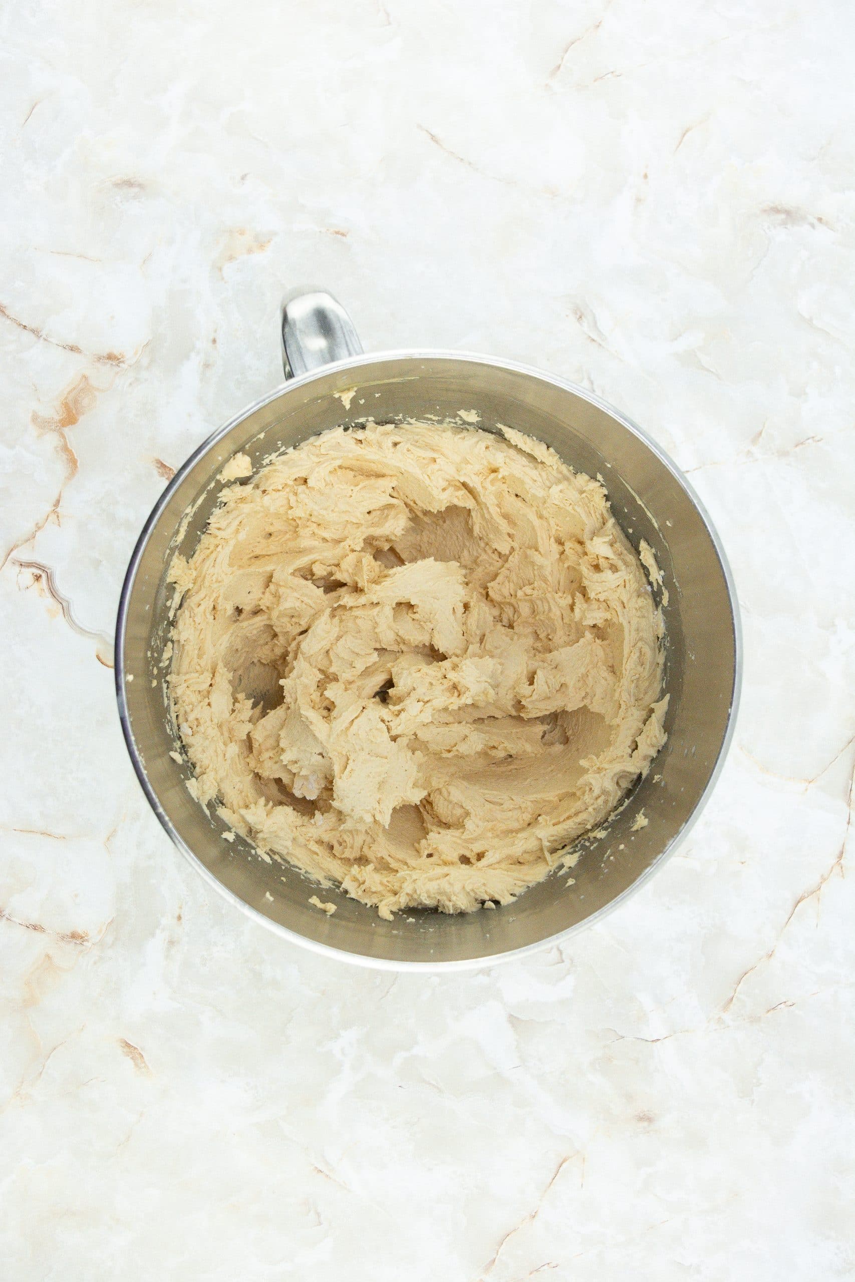 peanut butter frosting in a metal mixing bowl