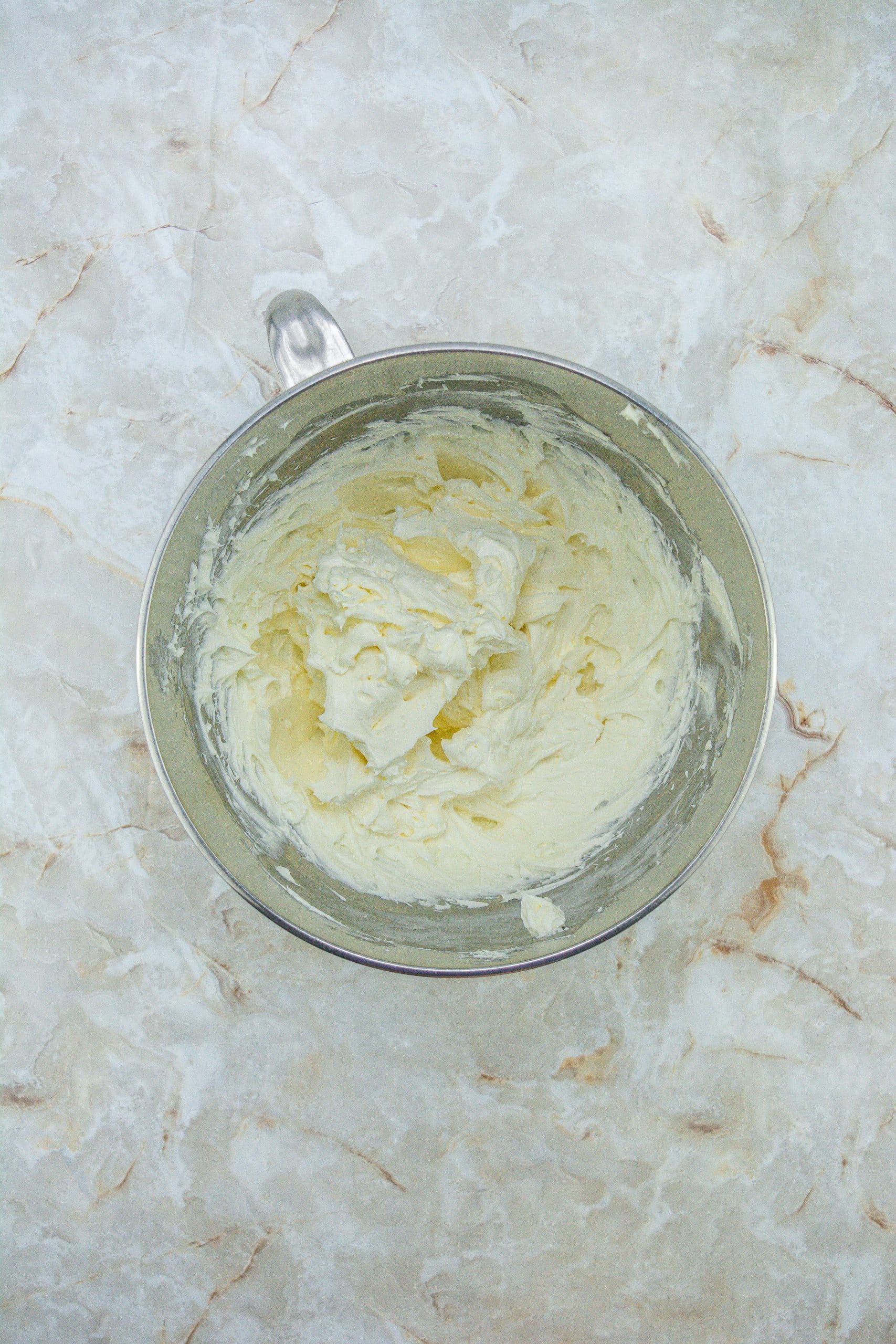 peppermint cheesecake filling in the bowl of a stand mixer