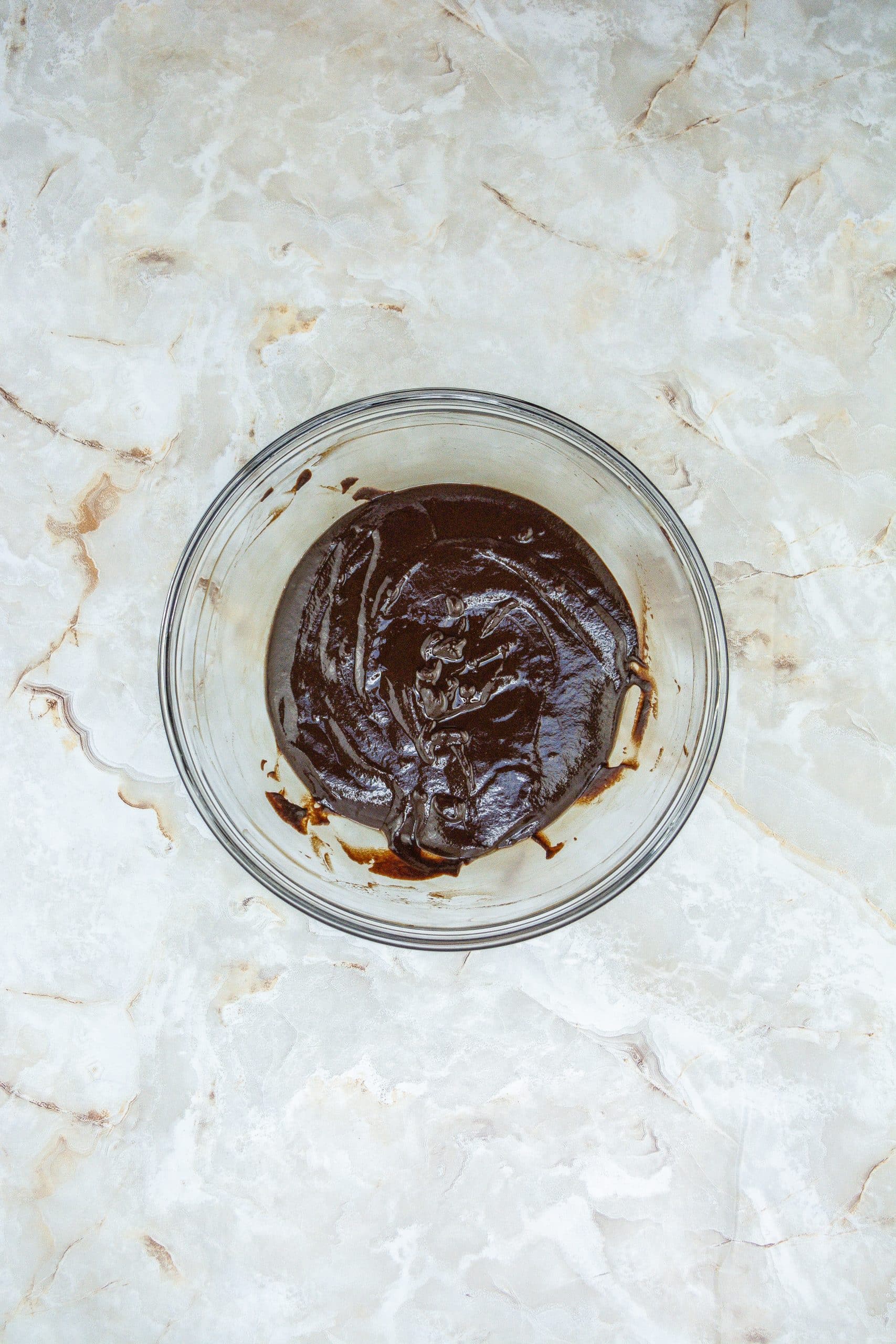 microwaved chocolate ganache in a glass mixing bowl