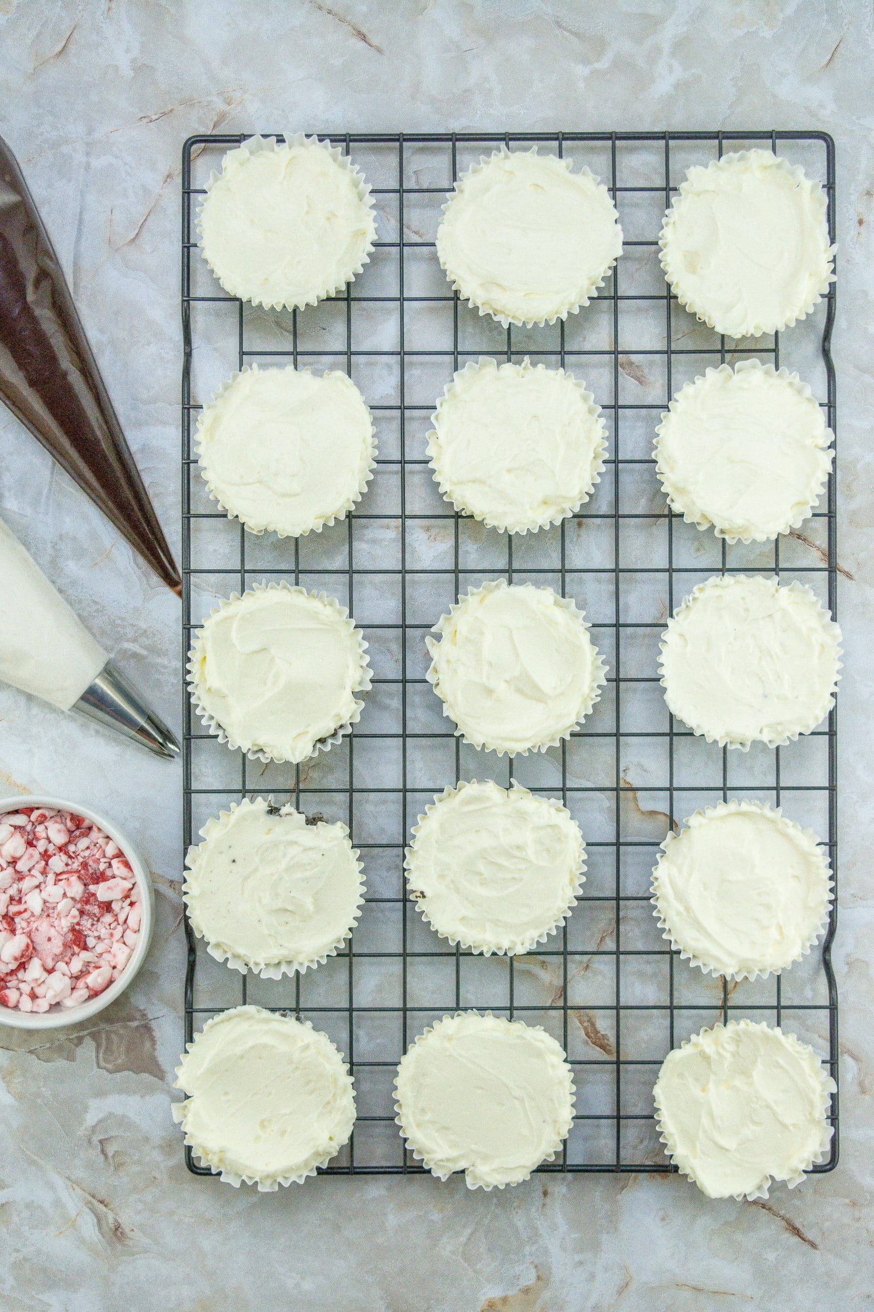 petite peppermint cheesecakes on a wire cooling rack