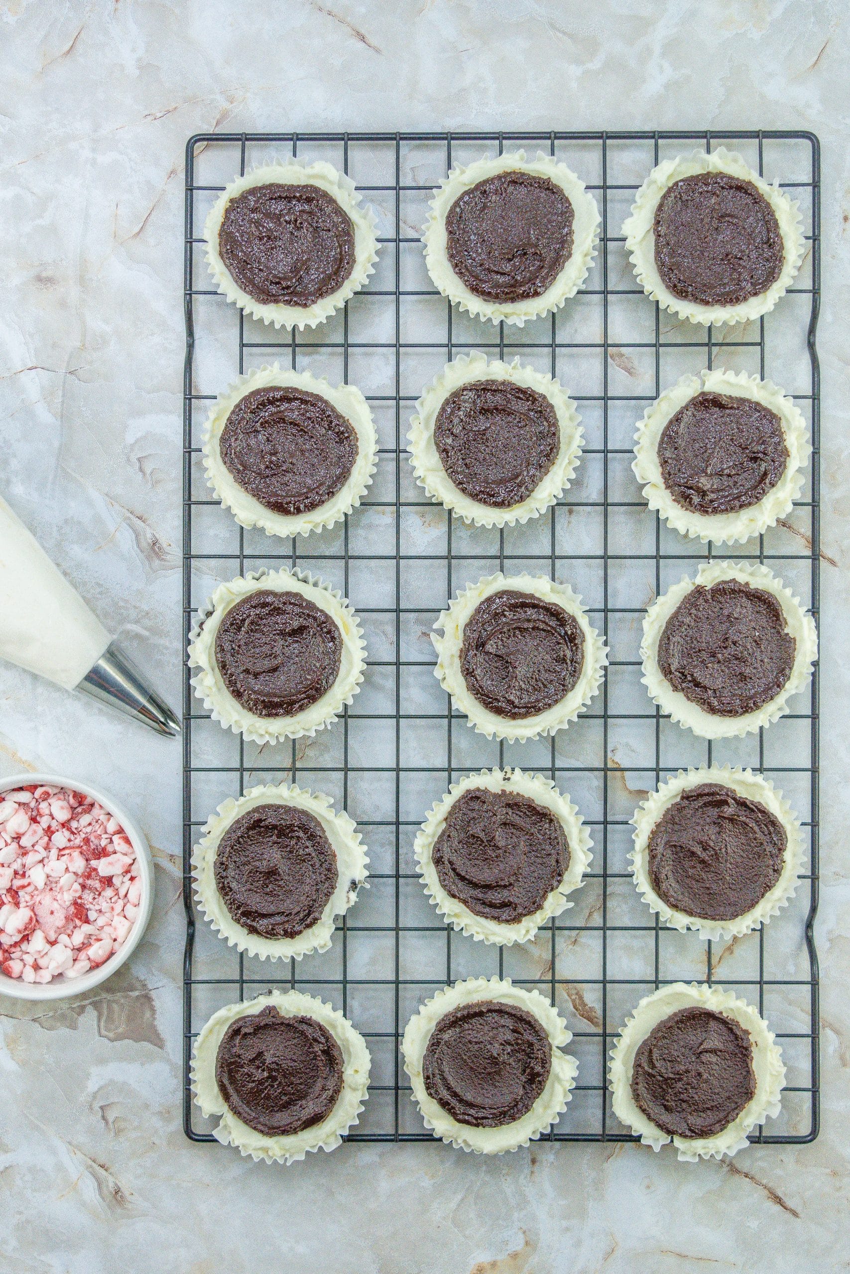 petite peppermint cheesecakes on a wire cooling rack