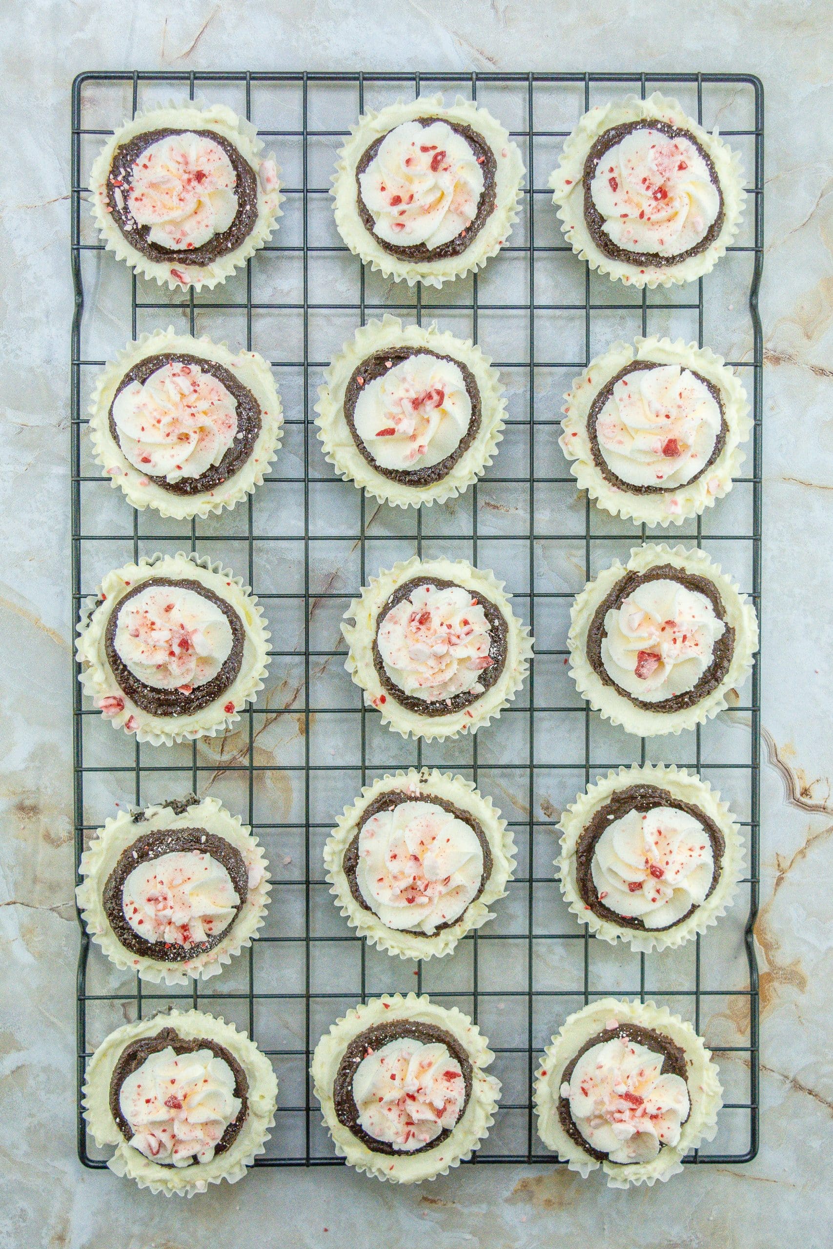 petite peppermint cheesecakes on a wire cooling rack