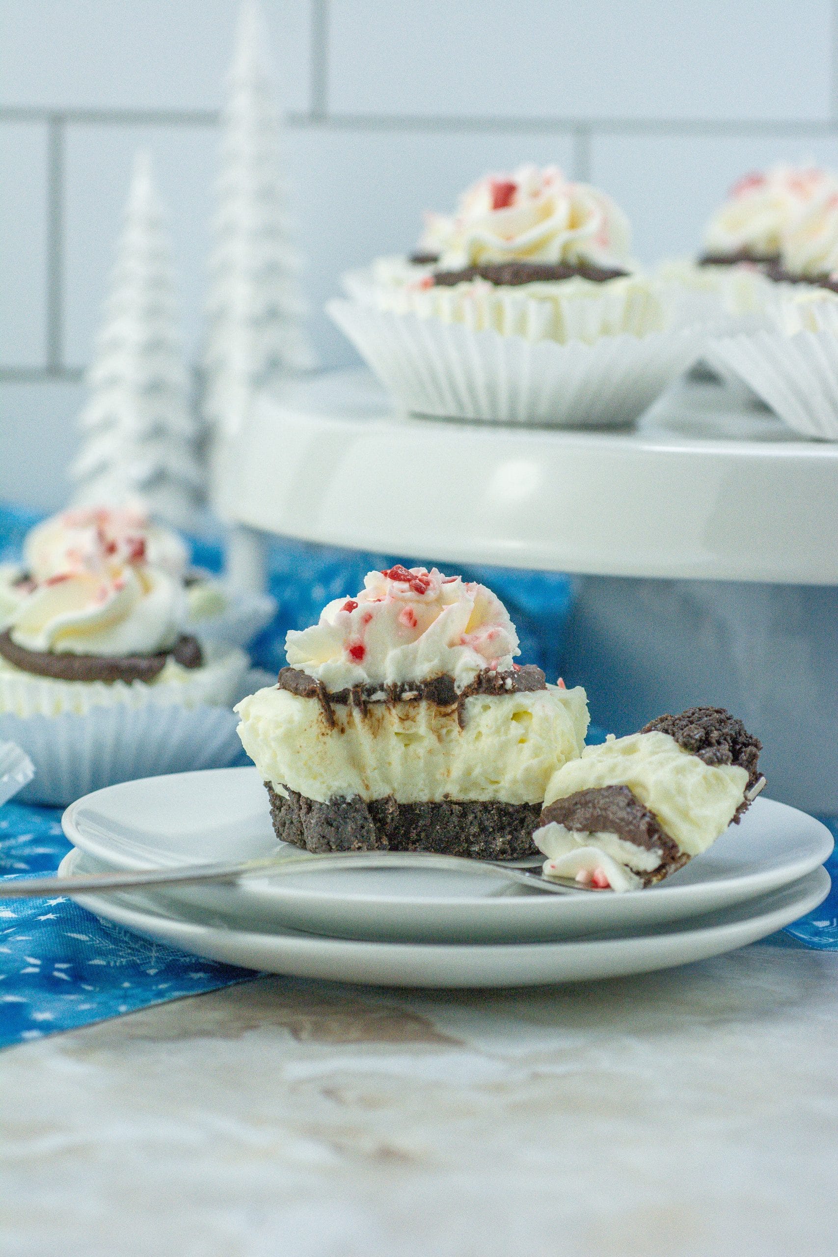 mini peppermint cheesecake on a white plate with a bite missing