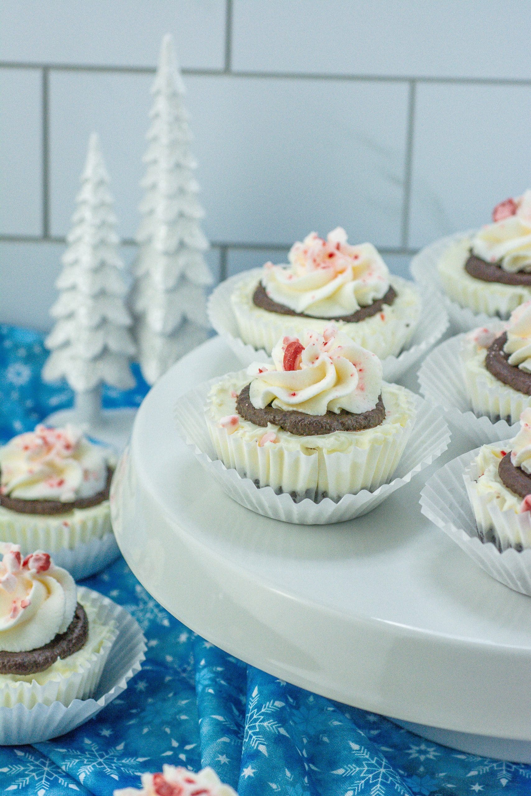 mini peppermint cheesecakes on white cake stand