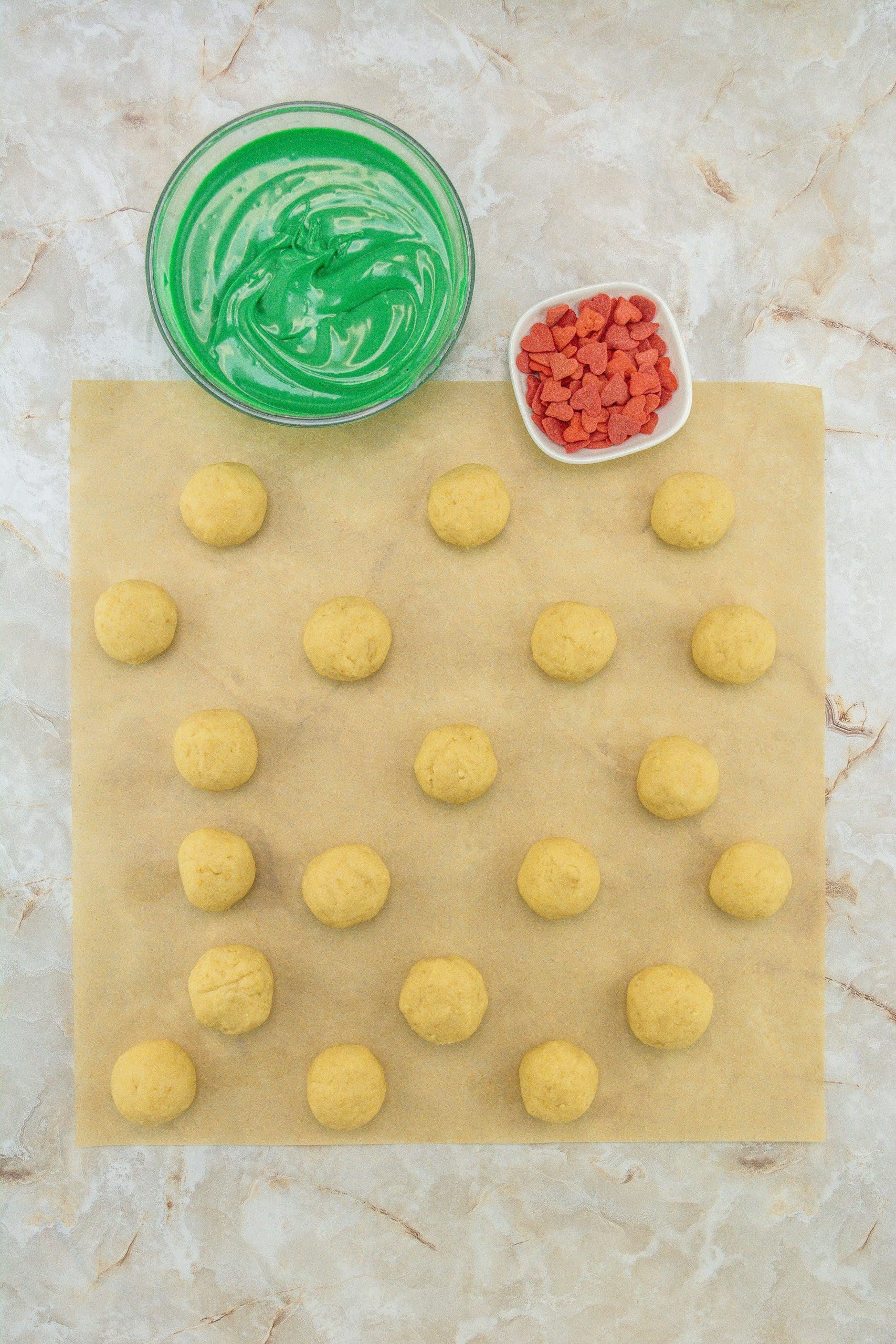 cake ball dough balls arrange in rows on a sheet of brown parchment paper
