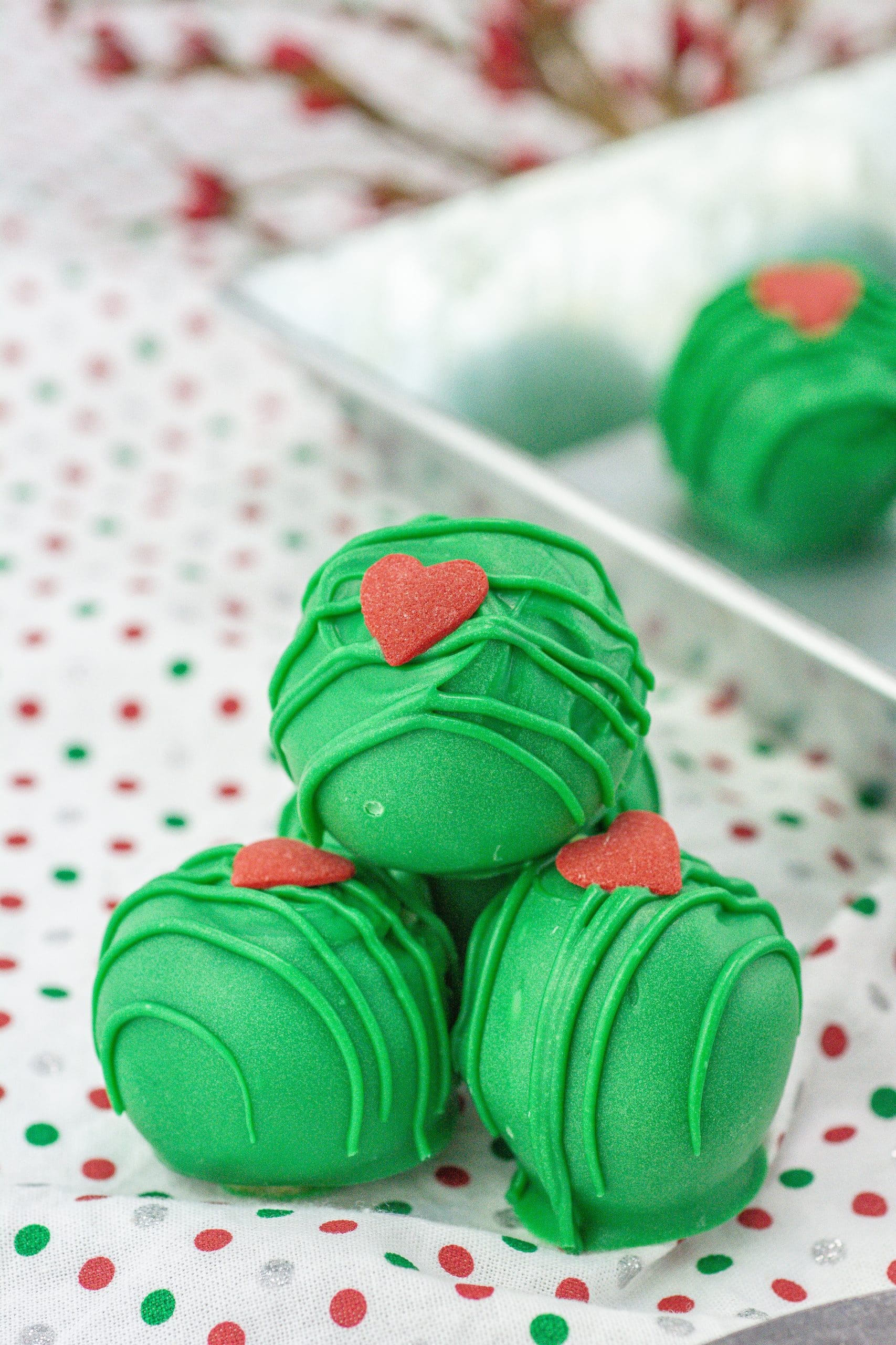 grinch truffles piled on a cloth napkin