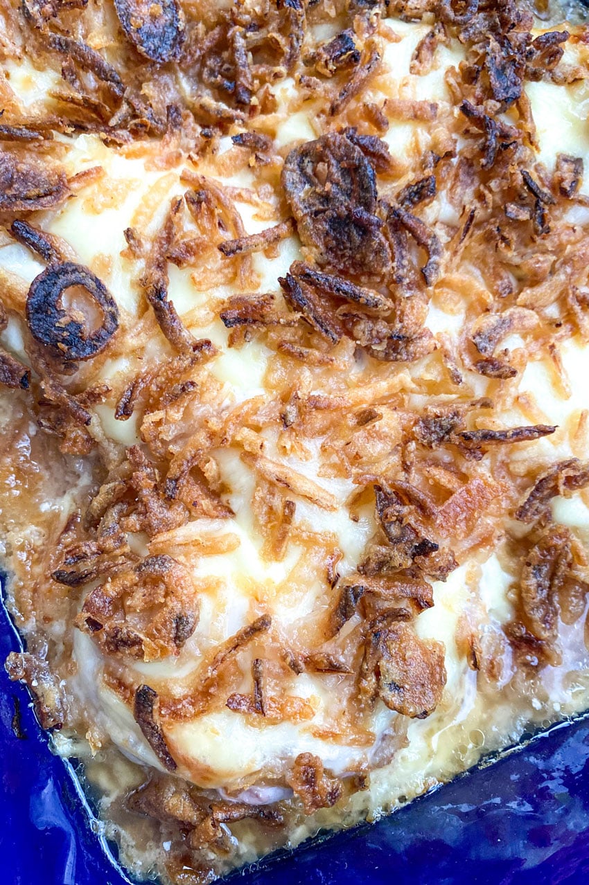 french onion pork chops in a large blue baking dish