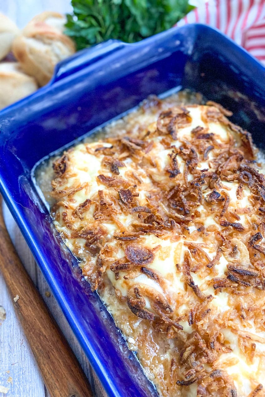 french onion pork chops in a large blue baking dish