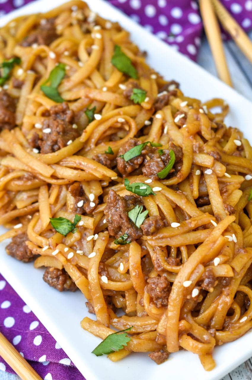 Mongolian Ground Beef & Noodles easy mongolian ground beef and noodles on a white platter with wooden chop sticks on the side