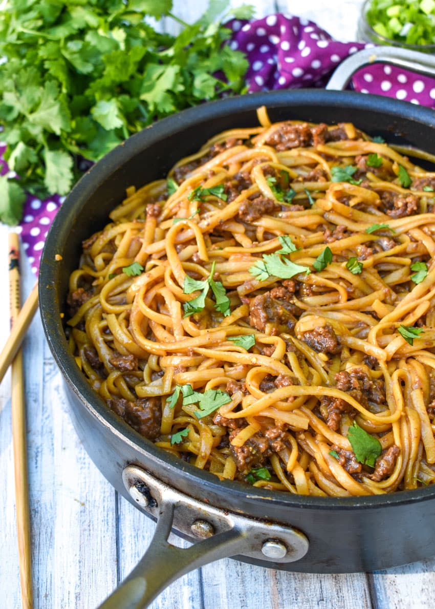 mongolian ground beef and noodles in a black skillet