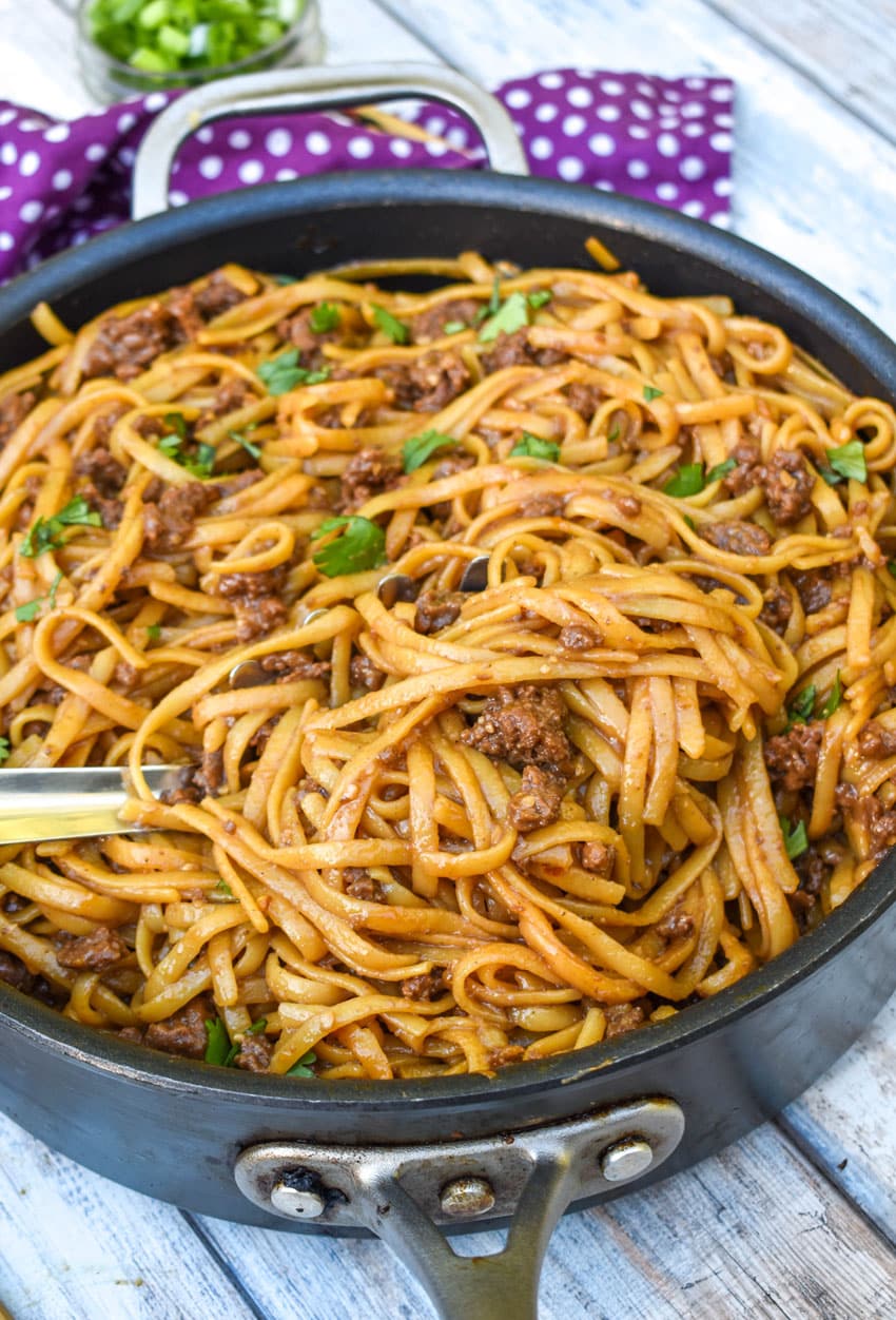 mongolian ground beef and pasta in a black skillet