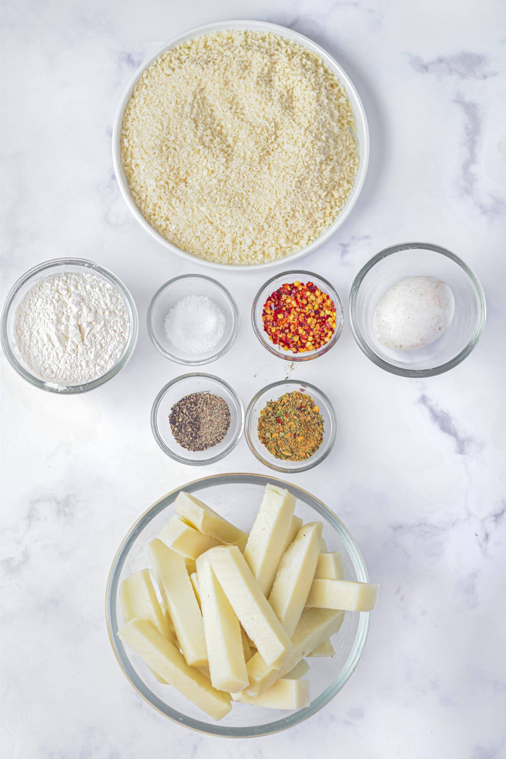 an overhead image showing the measured ingredients needed to make air fryer mozzarella sticks
