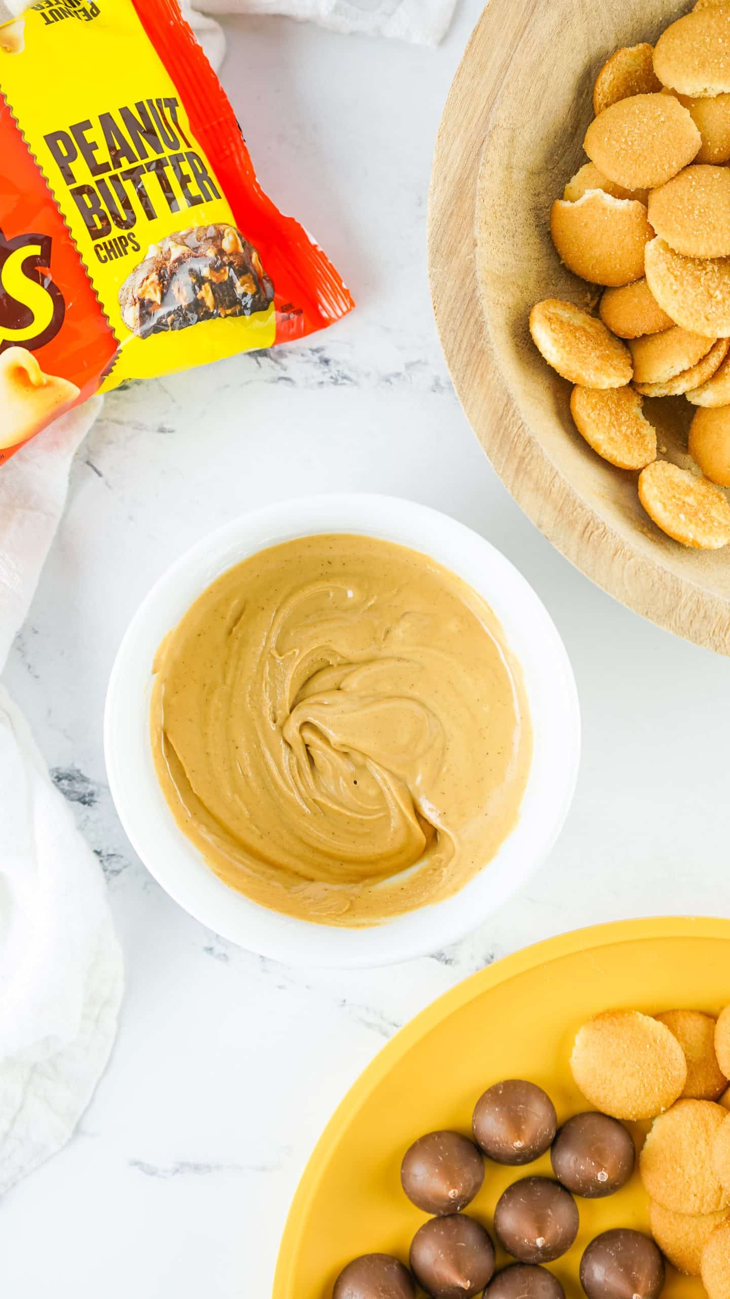 melted peanut butter chips in a small white bowl