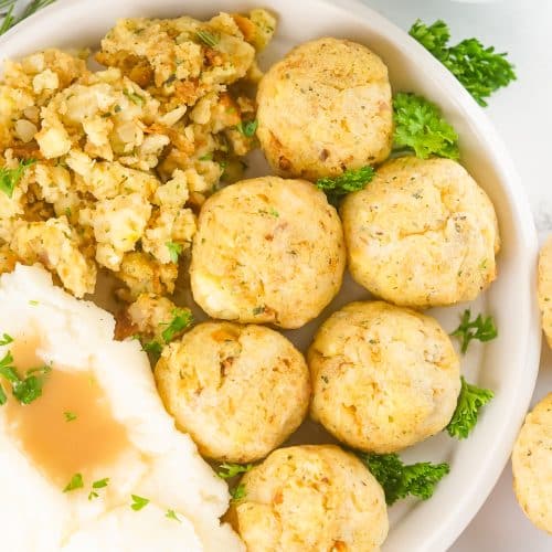 thanksgiving leftover turkey meatballs on a white plate with stuffing and mashed potatoes on the side
