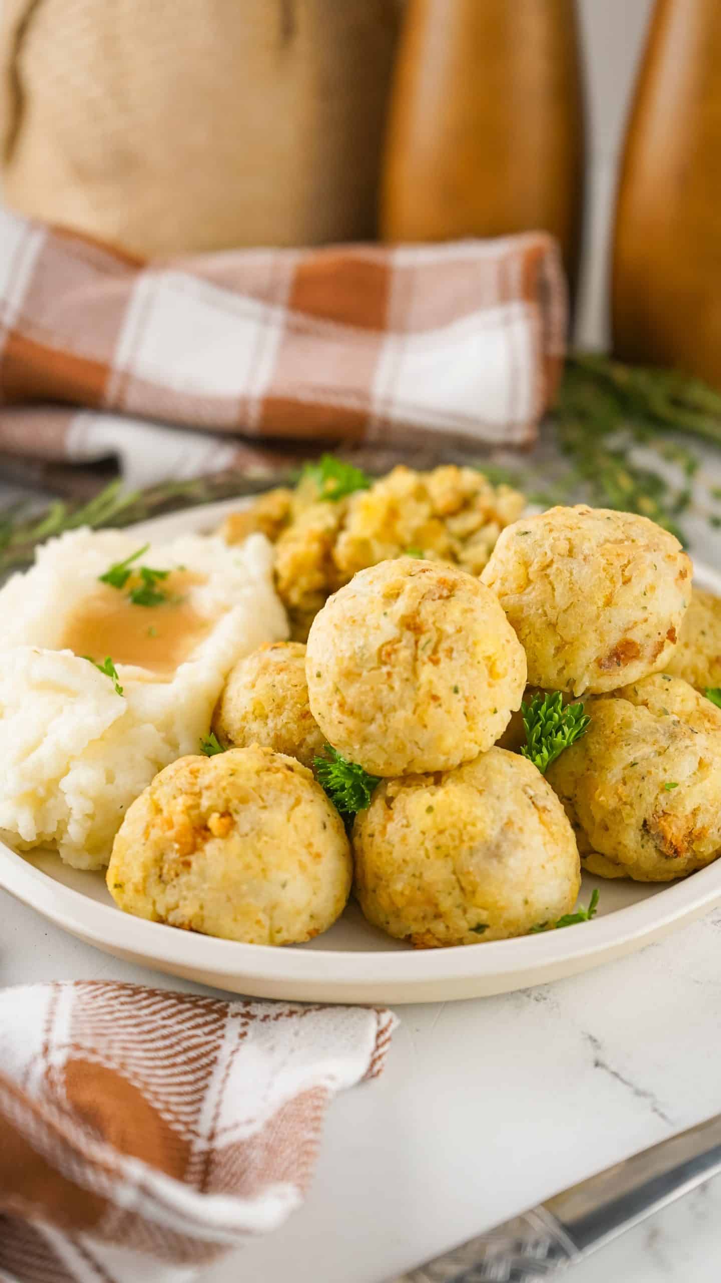 thanksgiving leftover turkey meatballs on a white plate with stuffing and mashed potatoes on the side