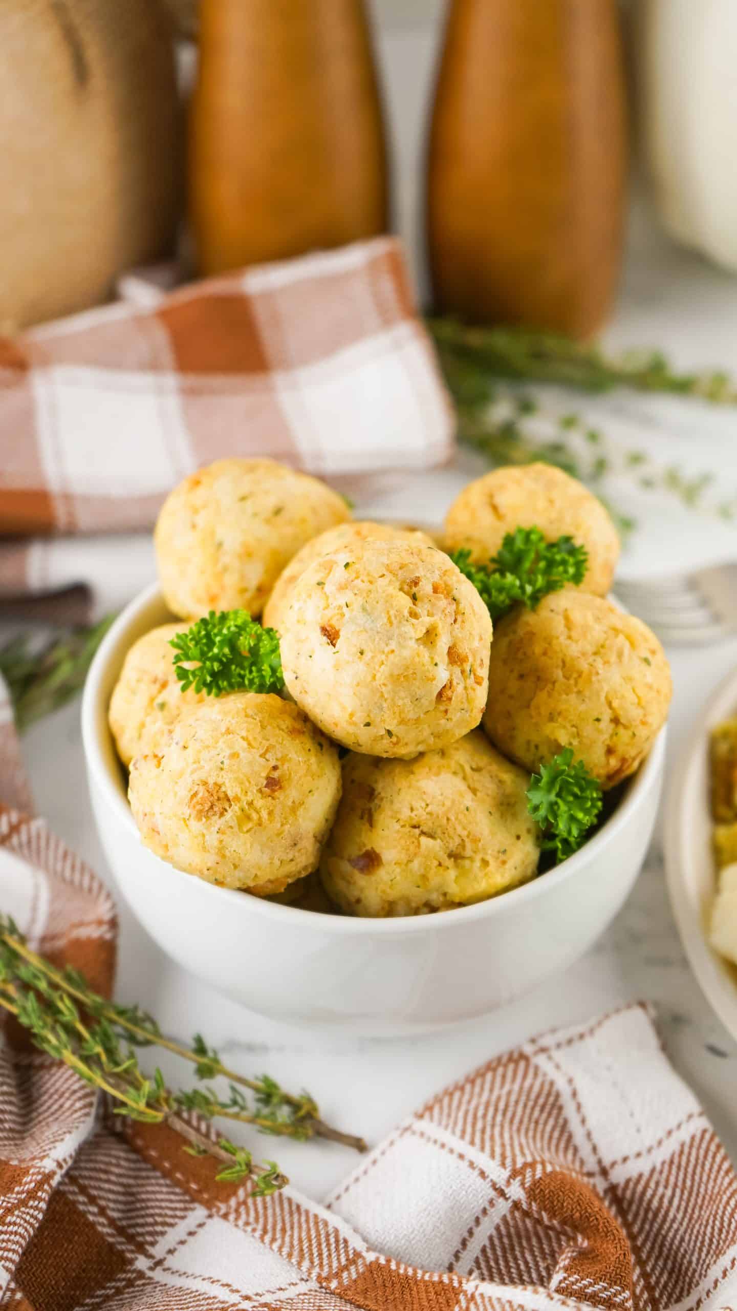 thanksgiving leftover turkey meatballs in a small white bowl with fresh green herbs
