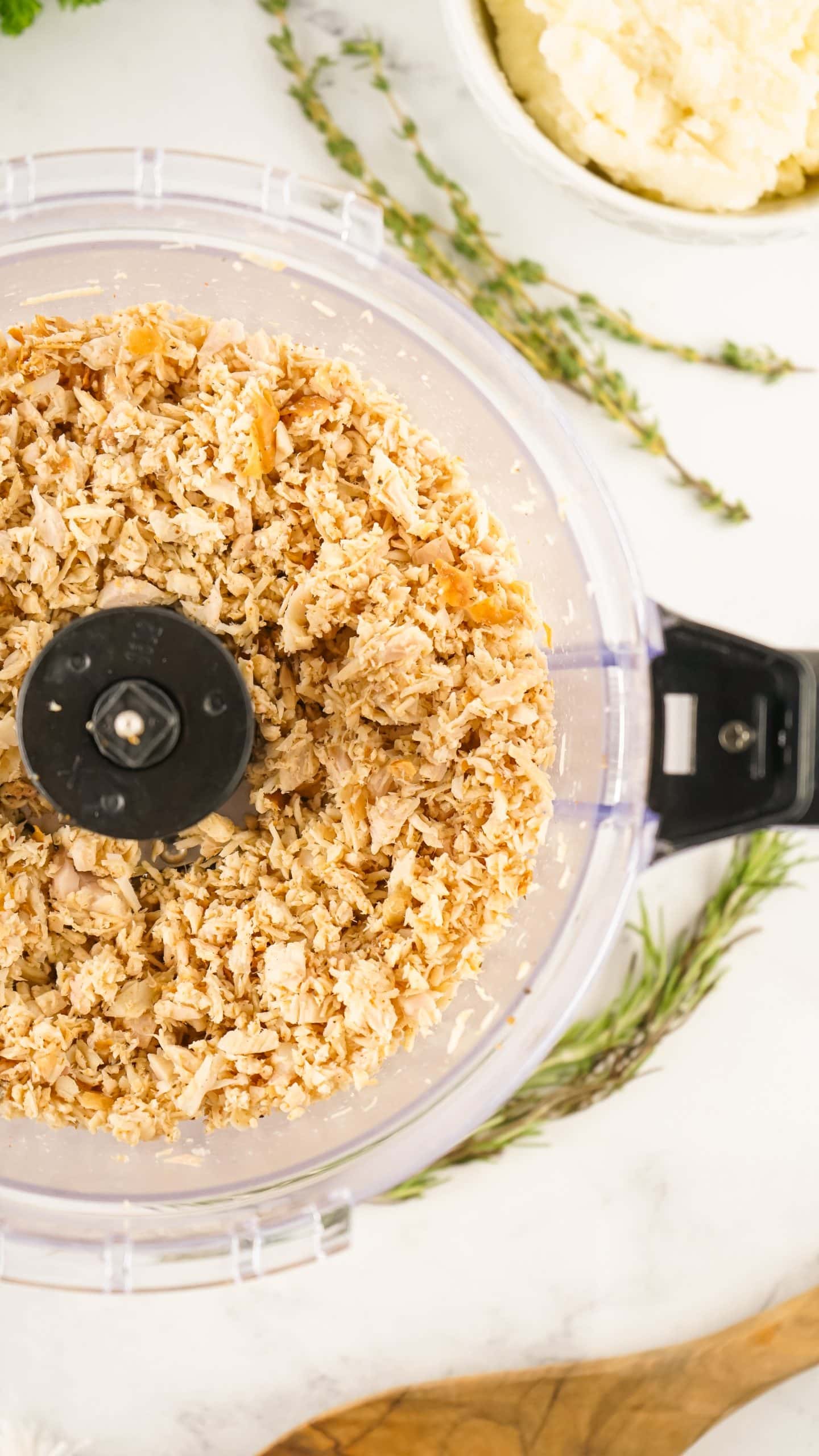minced leftover turkey in the bowl of a food processor