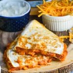 slices of chili cheese dog quesadillas on a wooden cutting board