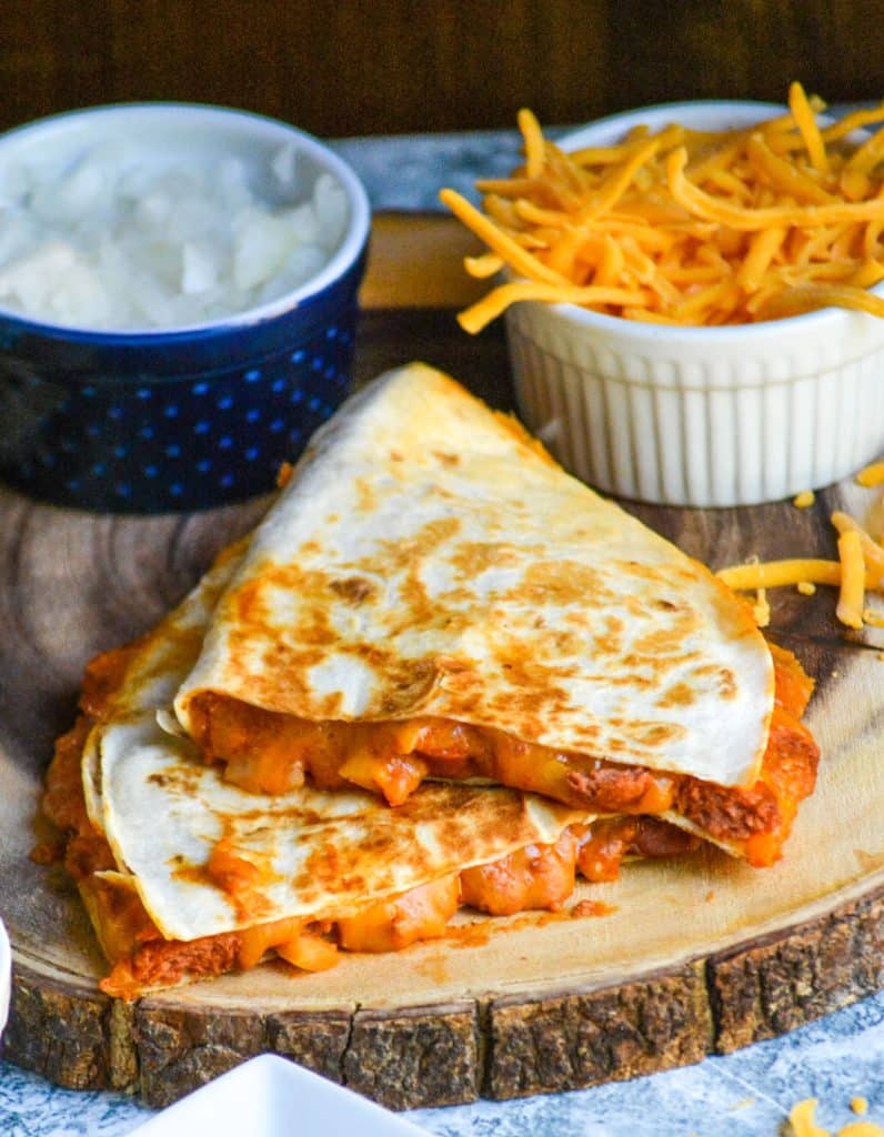 slices of chili cheese dog quesadillas on a wooden cutting board